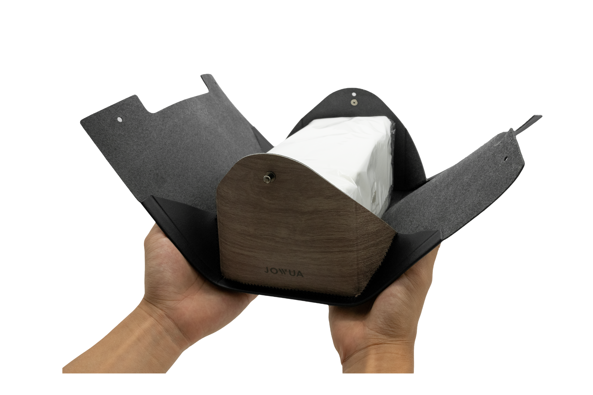 A pair of hands hold the JOWUA MagSafe Tissue Box Cover, crafted with premium microfiber leather for a stylish touch. It opens like a pouch to reveal its gray interior, complemented by a sleek black exterior. The wooden base features the engraved "JOWUA" logo, designed to perfectly integrate with accessories for Model 3/Y or your Jowua MagSafe Car Seat Holder setup.