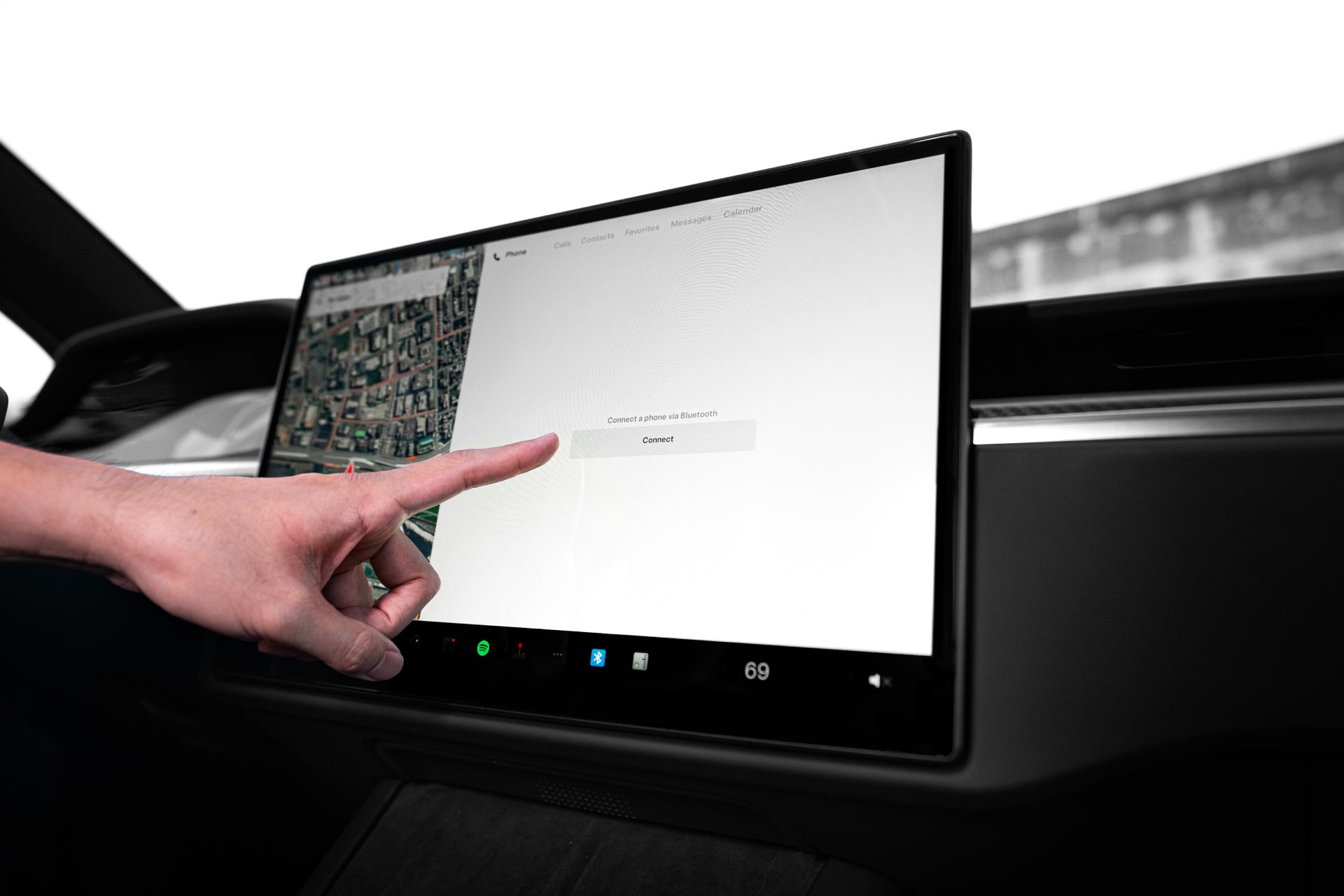 A hand is interacting with the large JOWUA dashboard touchscreen display, protected by a Tempered Glass Screen Protector (Model S/X) to resist fingerprints. The matte screen showcases a map on the left while presenting a connection prompt with a "Connect" button on the right, all set within a sleek, modern interior.