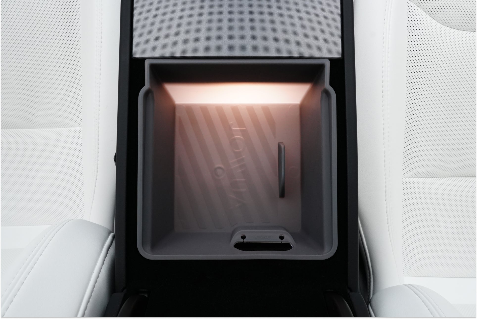 Close-up of the JOWUA Armrest Organizer Set for Tesla Model Y Juniper 2025+ / Model 3 Highland 2024+, shown in a light gray interior with "IONIQ" text and hybrid material for enhanced durability in the illuminated center console.