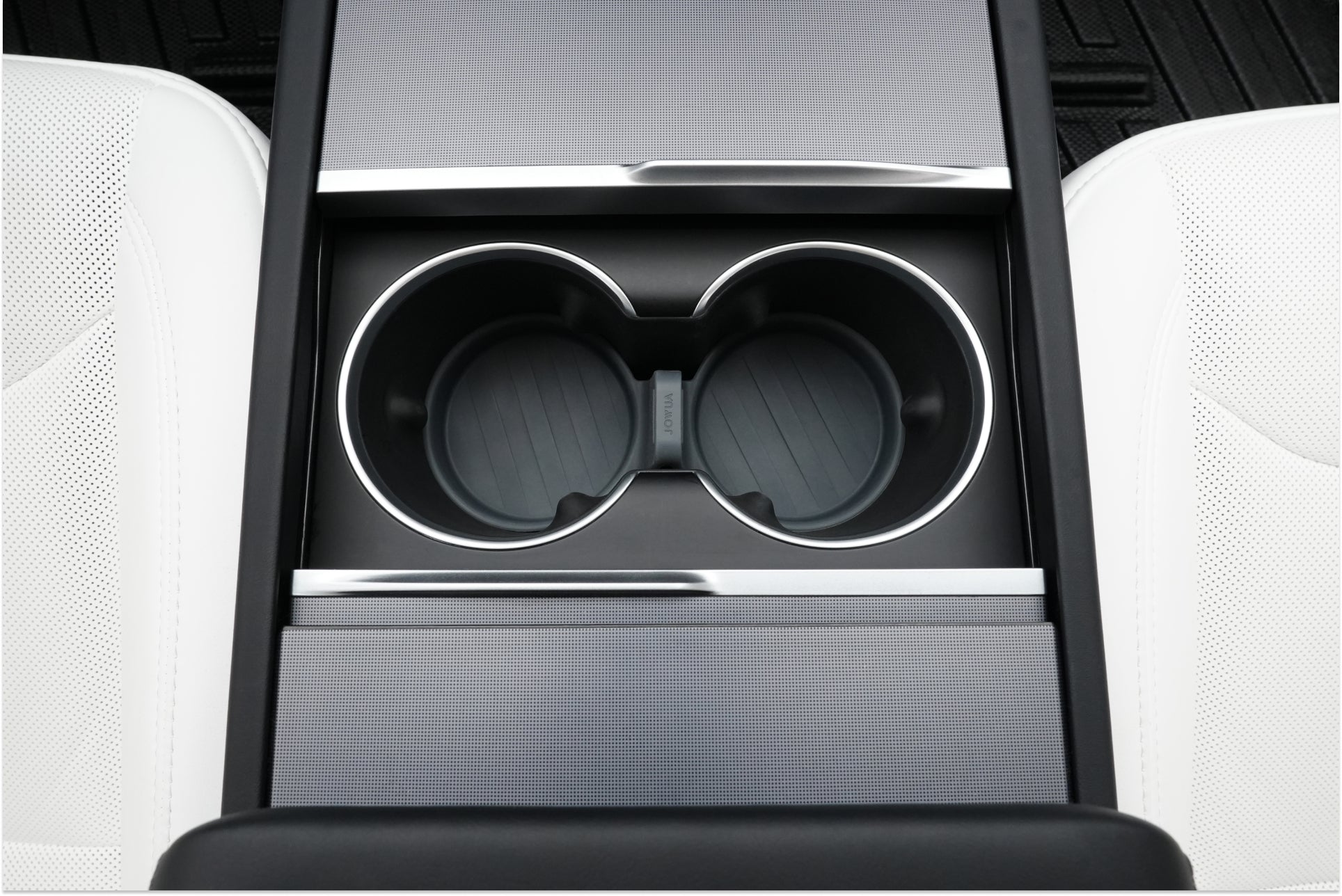 Top-down view of a Tesla Model 3’s center console with two empty cup holders and a sleek black and silver finish, surrounded by white leather seats—perfect for adding the JOWUA LED Center Console Combo (2024-2026+).