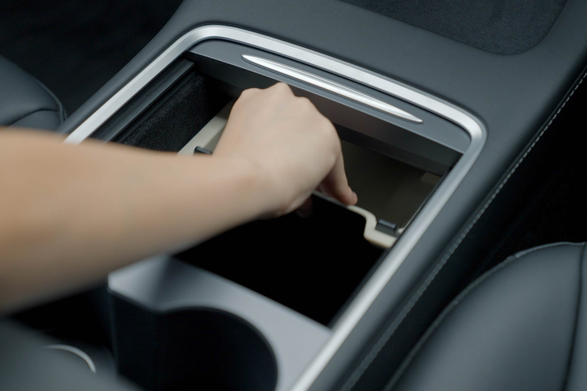 hand insert center console organizer in tesla car
