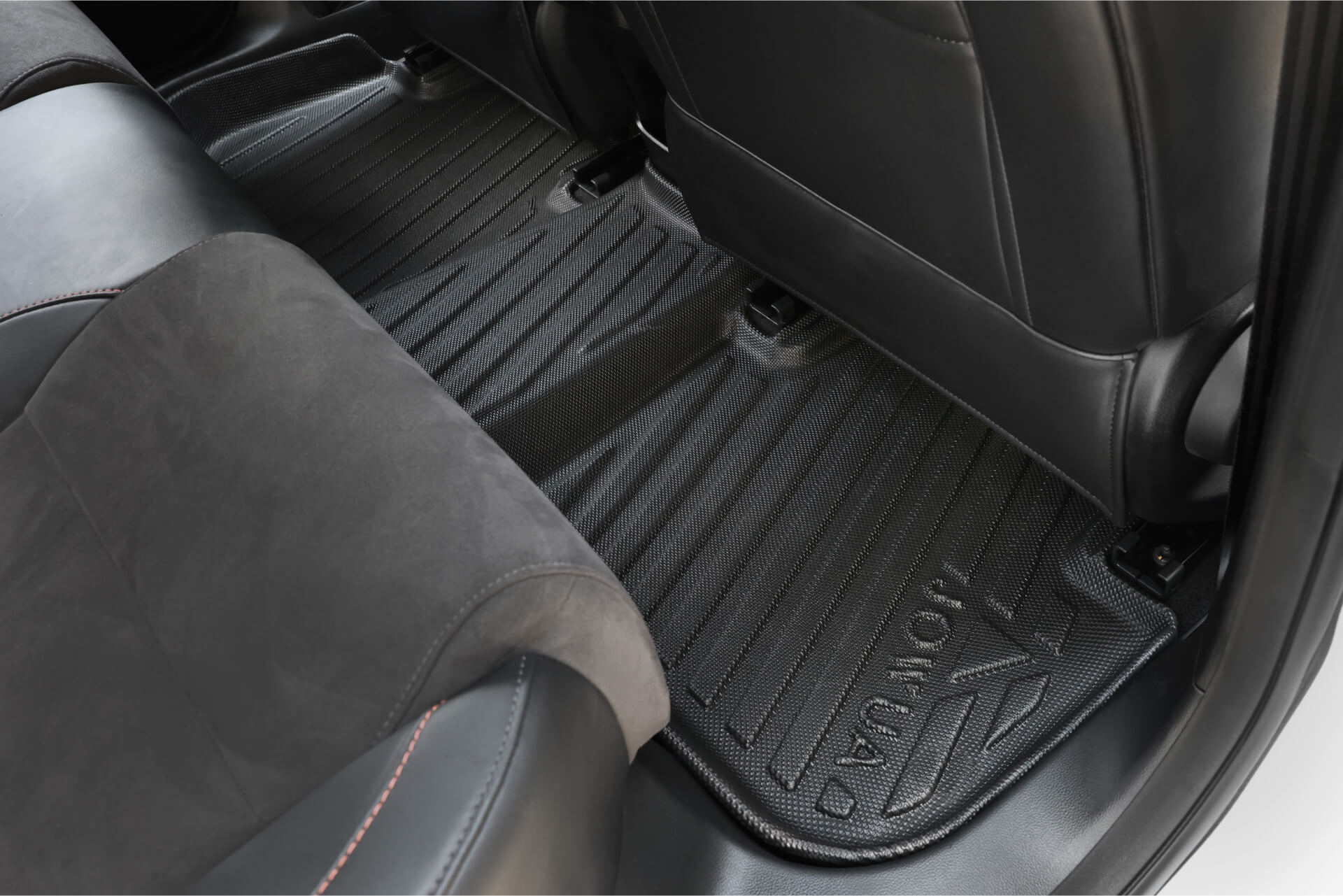 Close-up of a custom-fit JOWUA All Weather Floor Liner with a textured black surface, placed on the rear floor area between seats, designed for MG MG4 models.