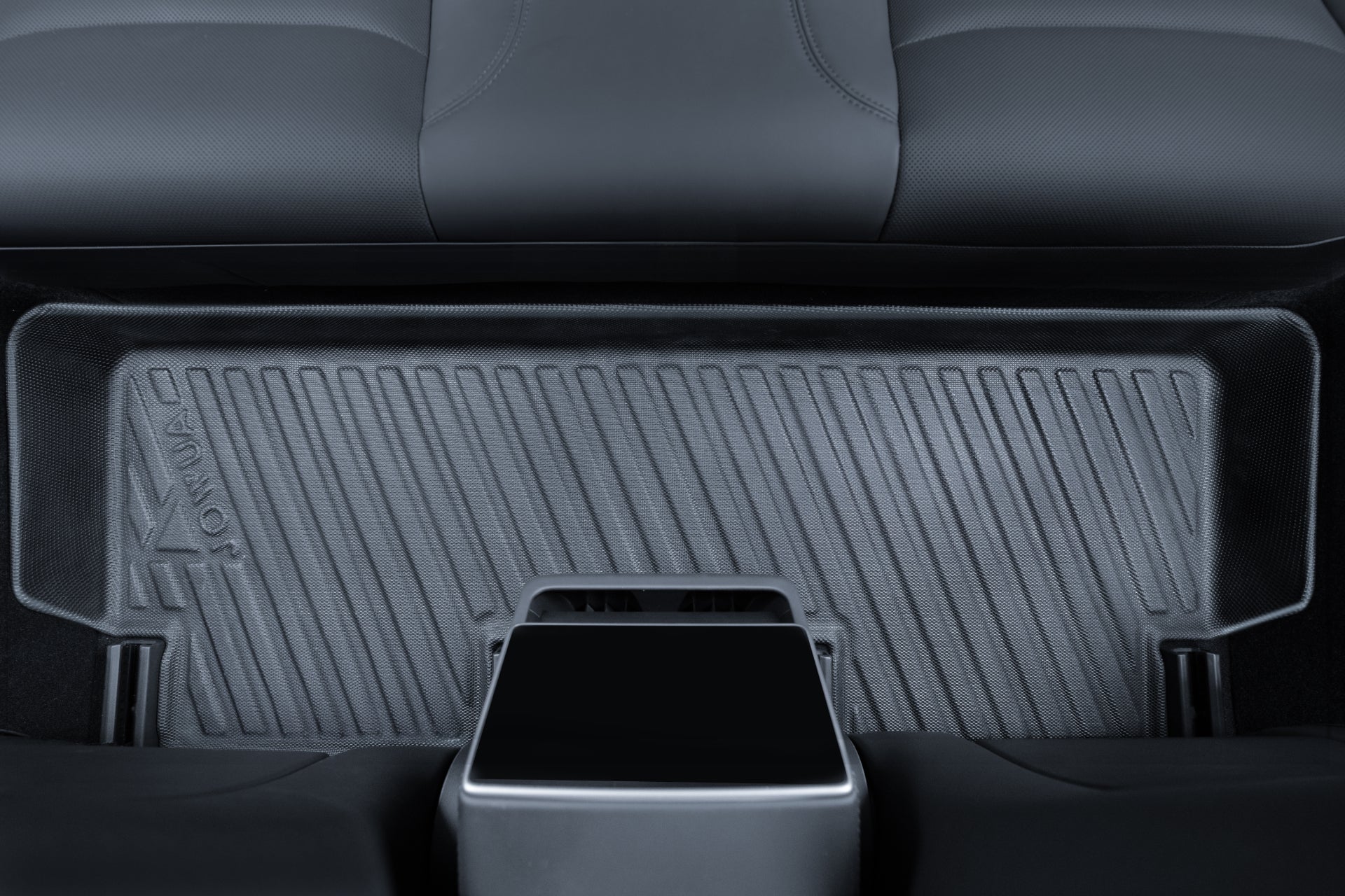 Close-up of JOWUA Model 3 (2024+ Highland) All-Weather Floor Liners in the rear footwell, with the back of the front center console and edge of a back seat visible.