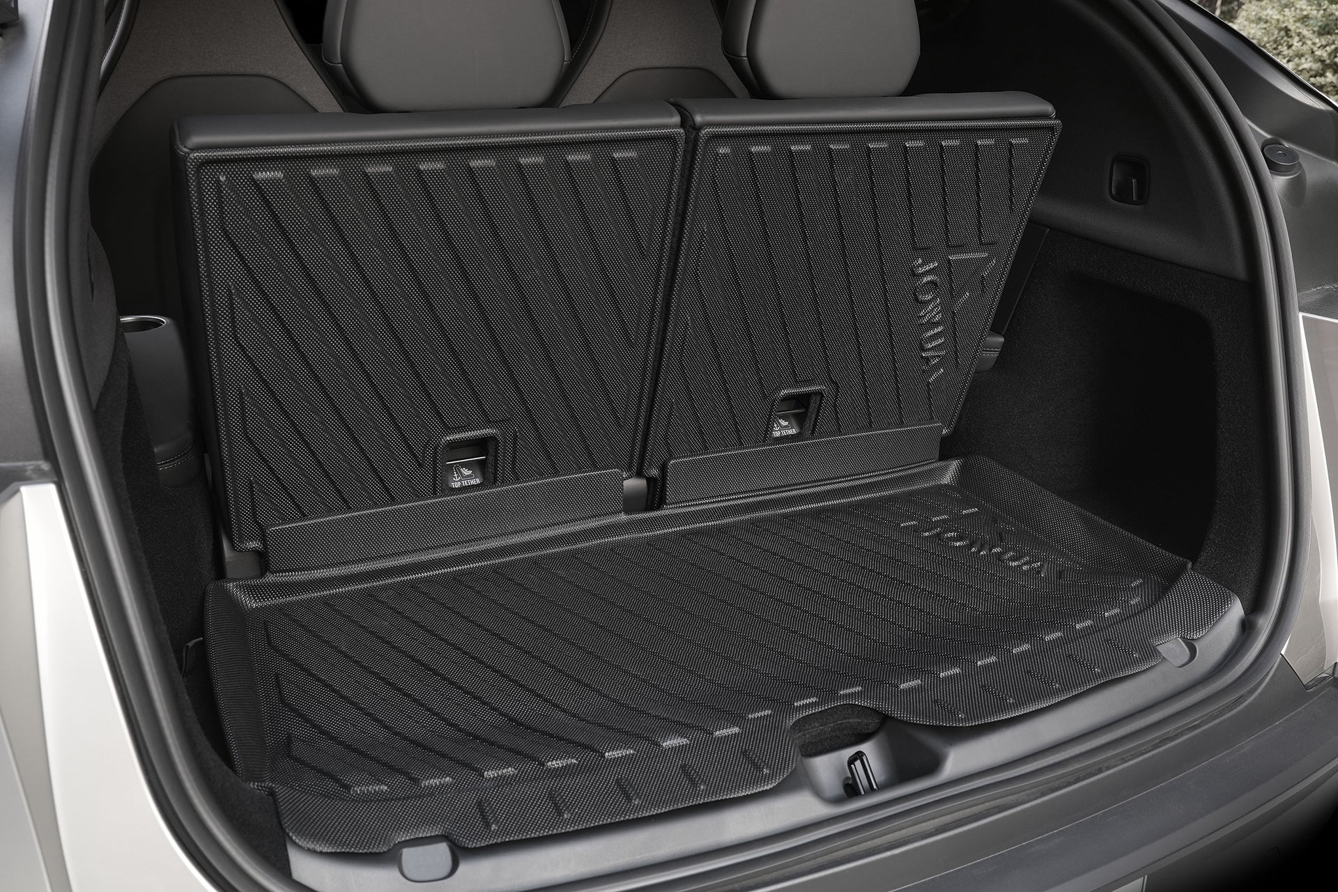 The image shows the rear cargo area of a vehicle with back seats upright, protected by JOWUA Model Y L (2026+) Interior/Trunk Full Coverage Liner Combo—durable liners with raised edges and textured surfaces for all-weather protection.