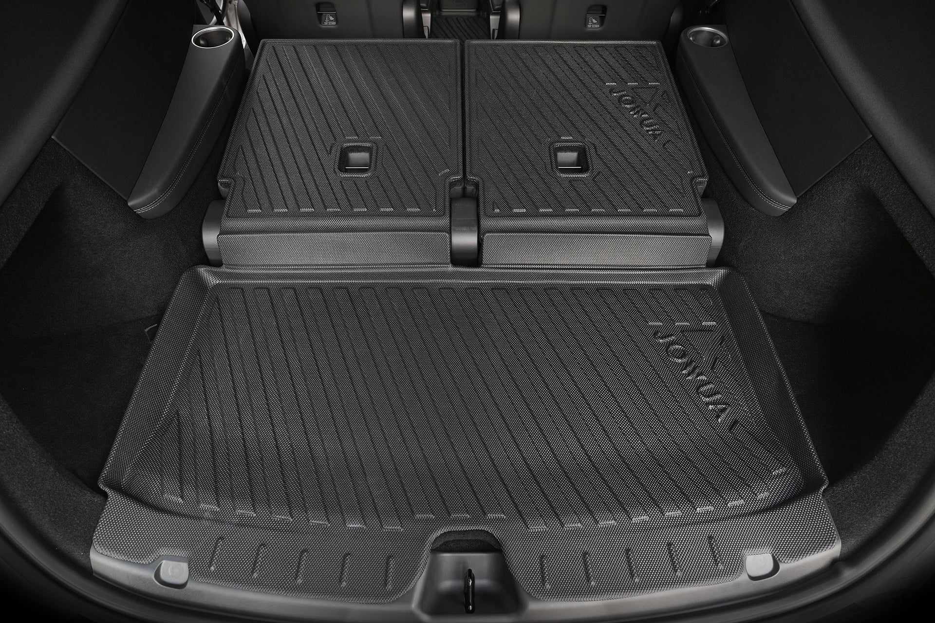 The image shows a JOWUA Model Y L (2026+) Interior / Trunk Full Coverage Liner Combo in the cargo area with the rear seats folded, providing a flat, protective surface similar to all-weather mats for carrying items.