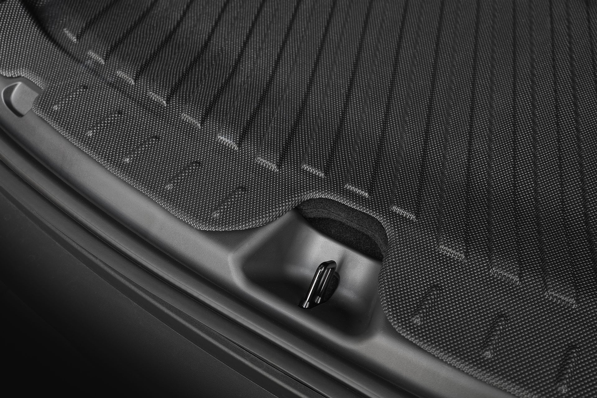 Close-up of the JOWUA Model Y L (2026+) Interior/Trunk Full Coverage Liner Combo, showing textured rubber, waterproof protection with raised lip edges and a cut-out handle area near the latch.