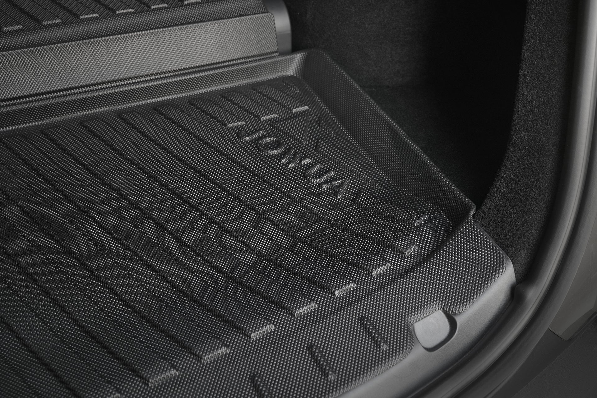 Close-up of a black JOWUA Model Y L (2026+) Interior/Trunk Full Coverage Liner Combo installed, featuring textured grooves and raised edges for all-weather protection—ideal for keeping your Tesla trunk clean and protected.