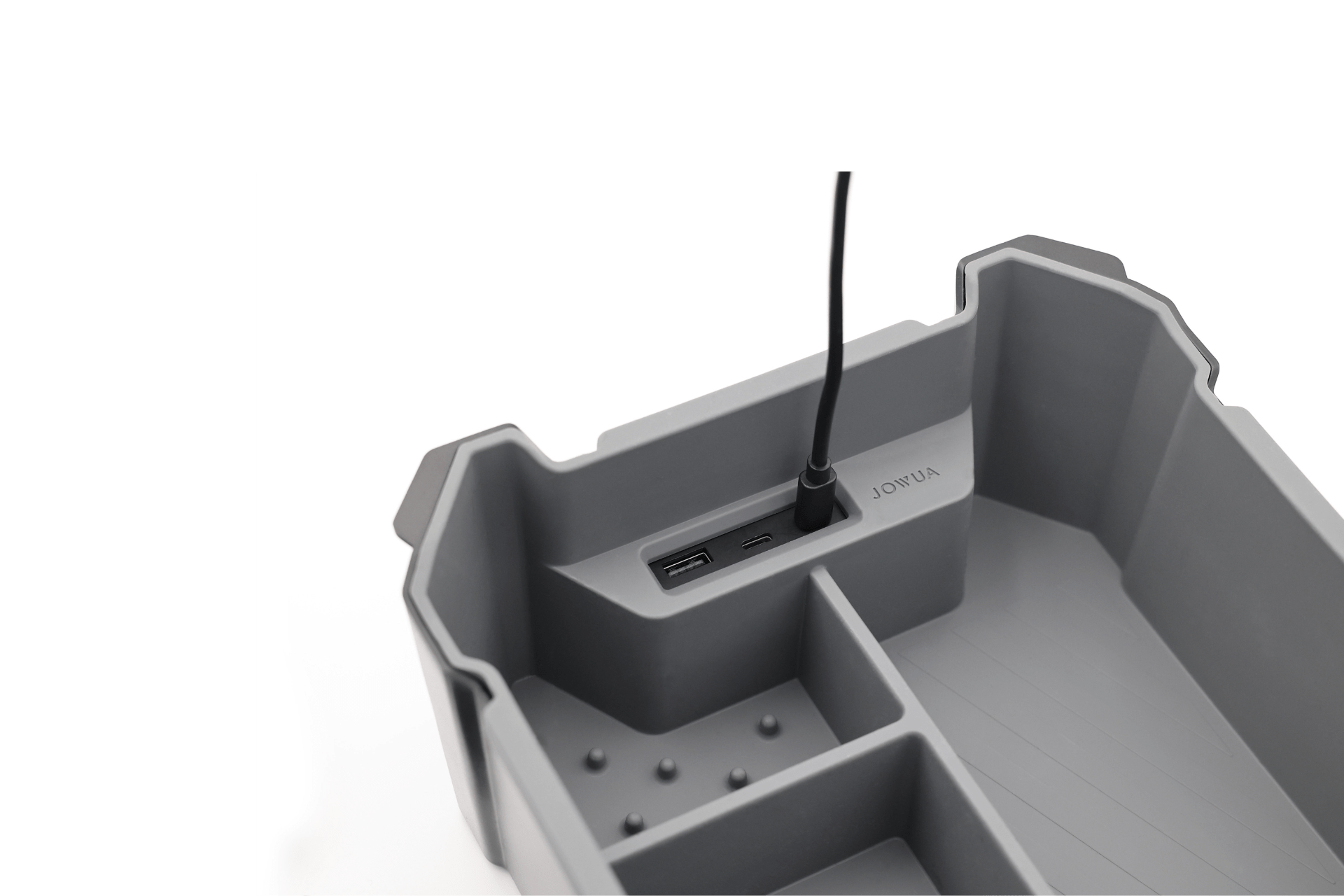 A gray Center Console Set (Tesla Cybertruck) by JOWUA features compartments, two USB ports, and a charging cable plugged in, resembling a Tesla Cybertruck organizer, with the JOWUA brand name shown against a clean white background.