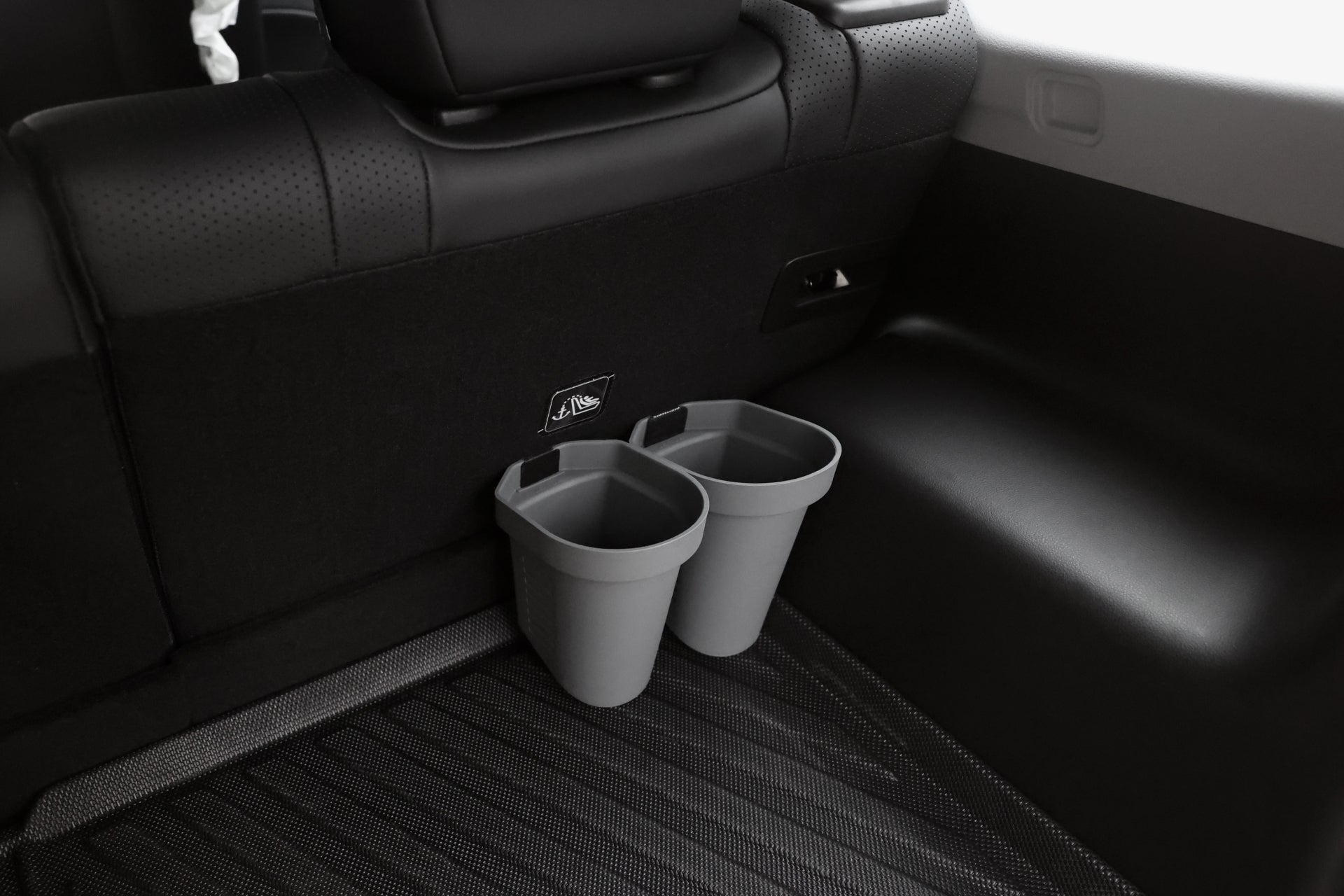 Two JOWUA Door Side Storage Boxes (set of 2) are attached to the back of a car seat above the black floor mats in the rear passenger area.