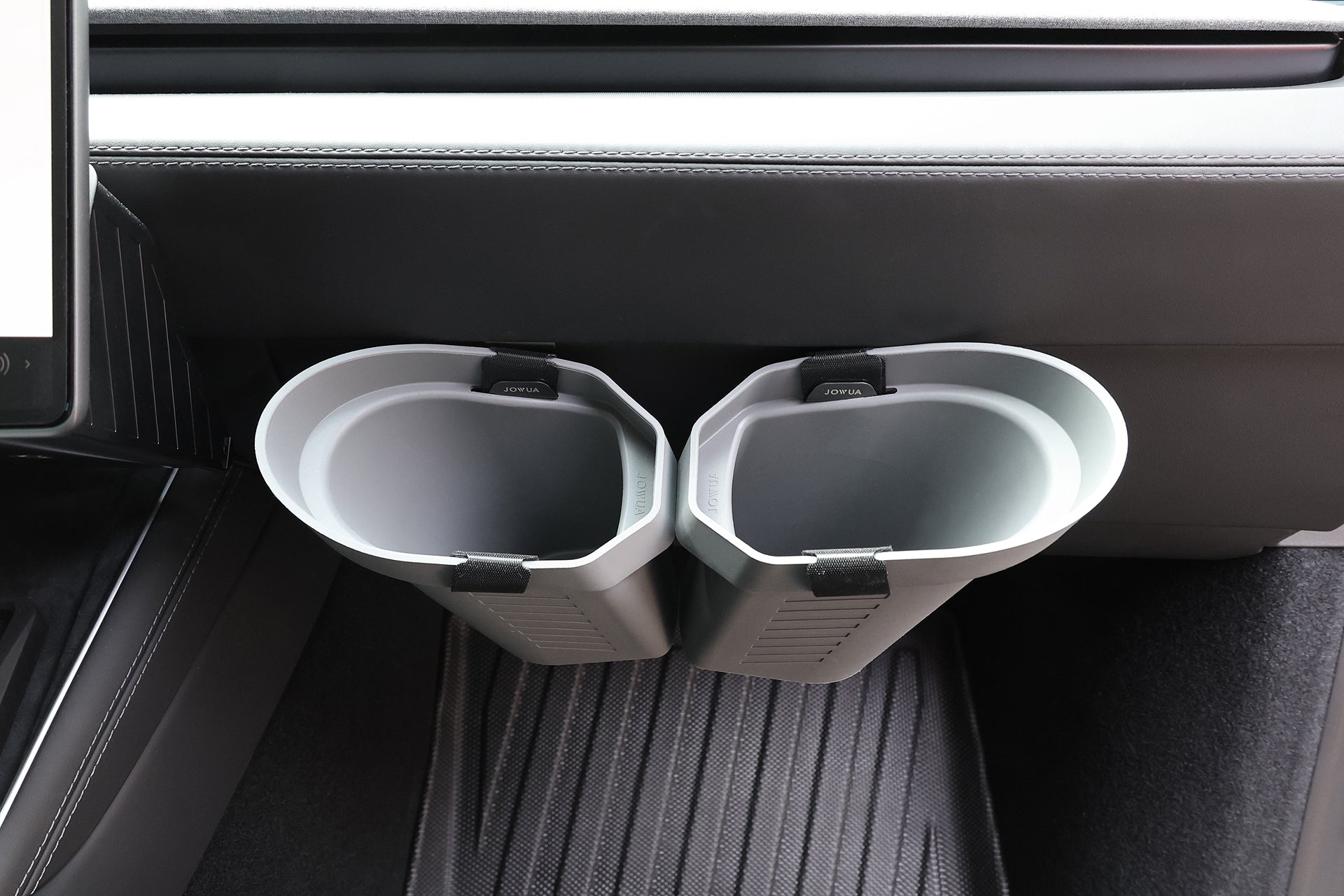 Two gray, oval-shaped JOWUA Door Side Storage Boxes (Set of 2) attach side by side to the back of a car’s center console above the floor mat—an ideal spot for additional storage and convenience.