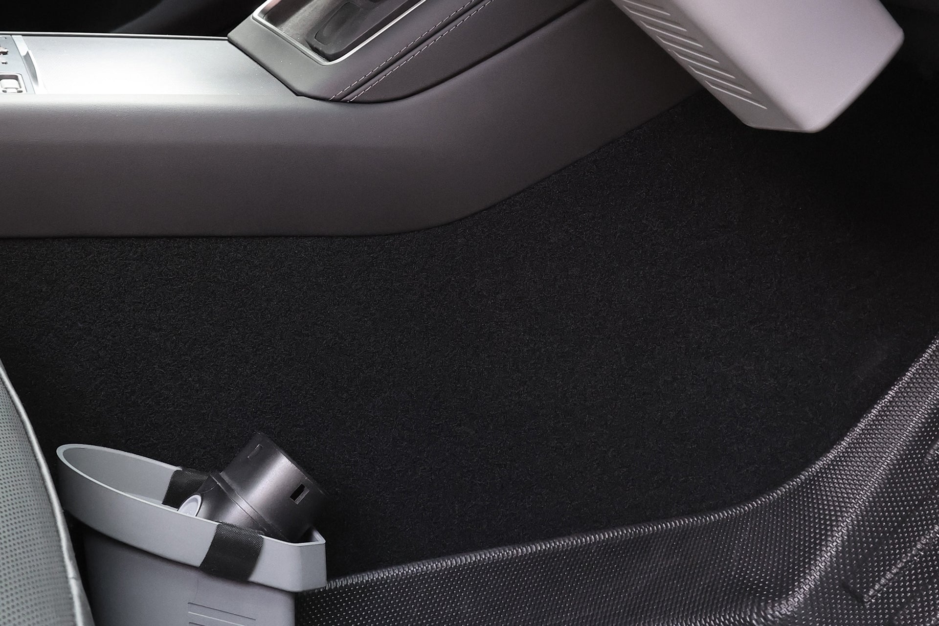 The JOWUA Door Side Storage Box (Set of 2) in gray silicone is attached to the center console near the passenger seat footwell, with a black garbage bag included.