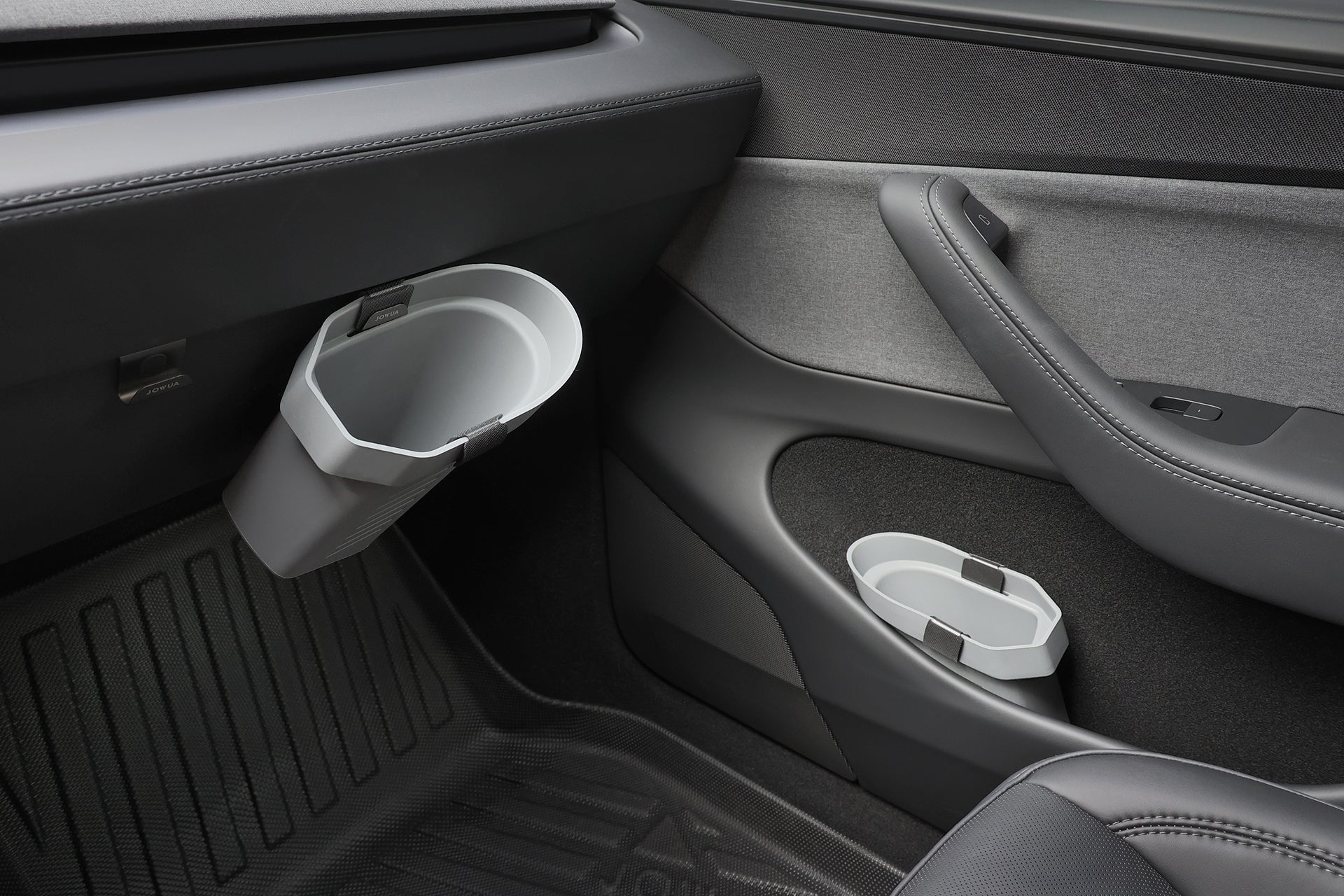 Close-up of a car door interior with JOWUA's Door Side Storage Box (Set of 2) as gray cup holders near the armrest and on the door panel, both displaying a modern, minimalist design.