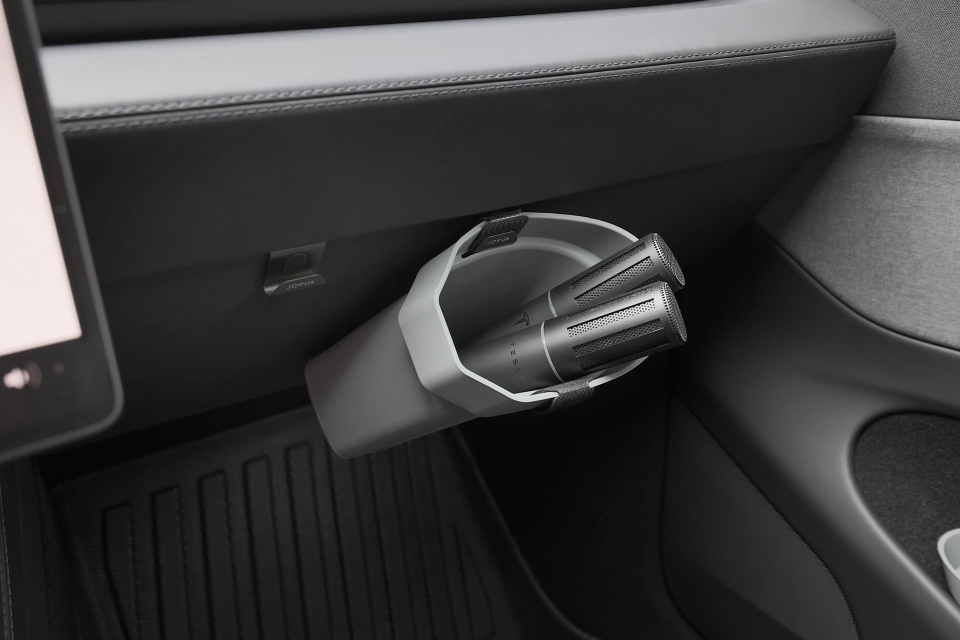 A gray JOWUA Door Side Storage Box (Set of 2) is attached to the car’s dashboard, holding two black handheld vacuum attachments above the front passenger floor mat.