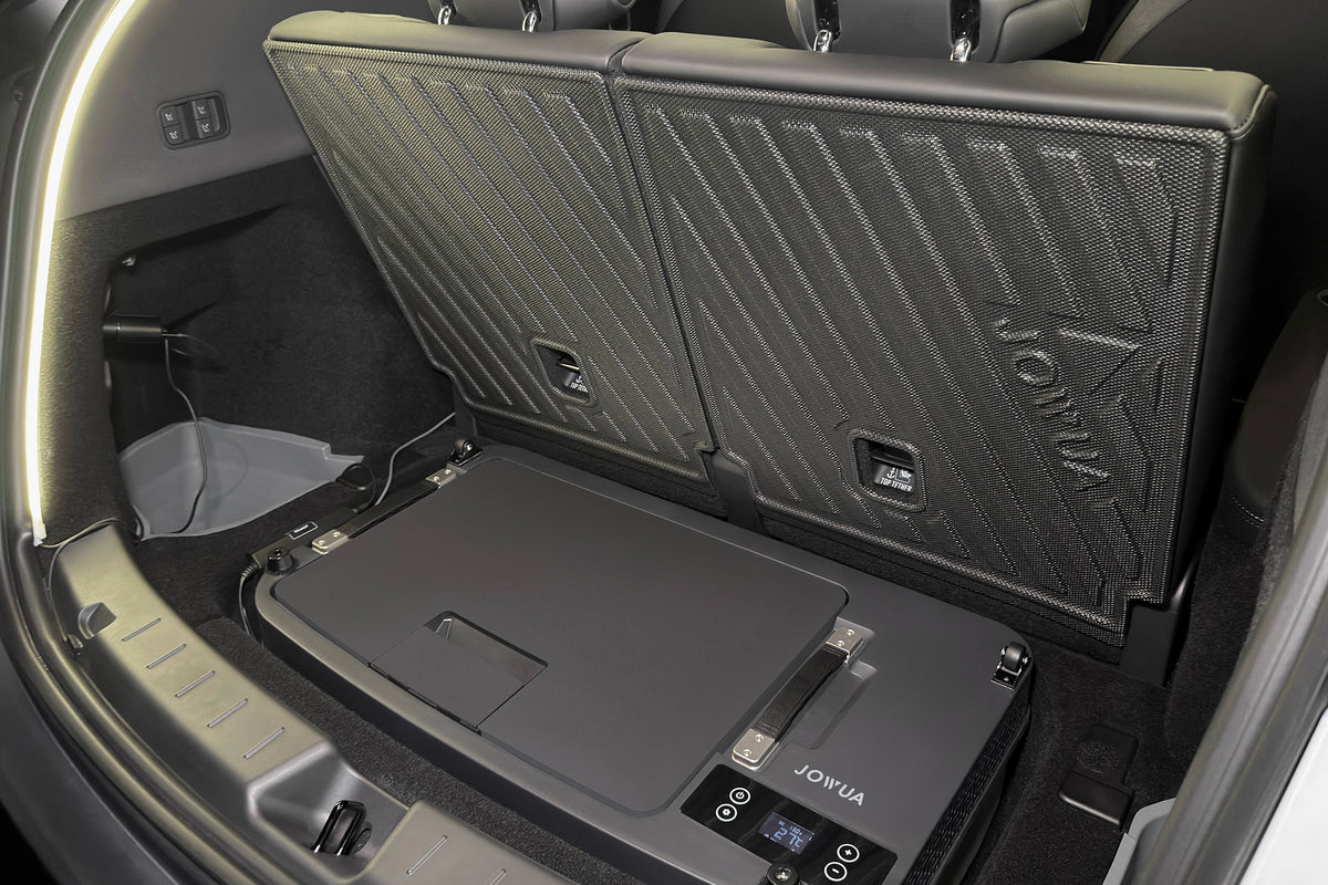 A JOWUA Car Refrigerator for Tesla Model Y L (2026+) with intelligent dual-mode cooling installed in the cargo area of a vehicle, sitting flat behind the upright rear seats.