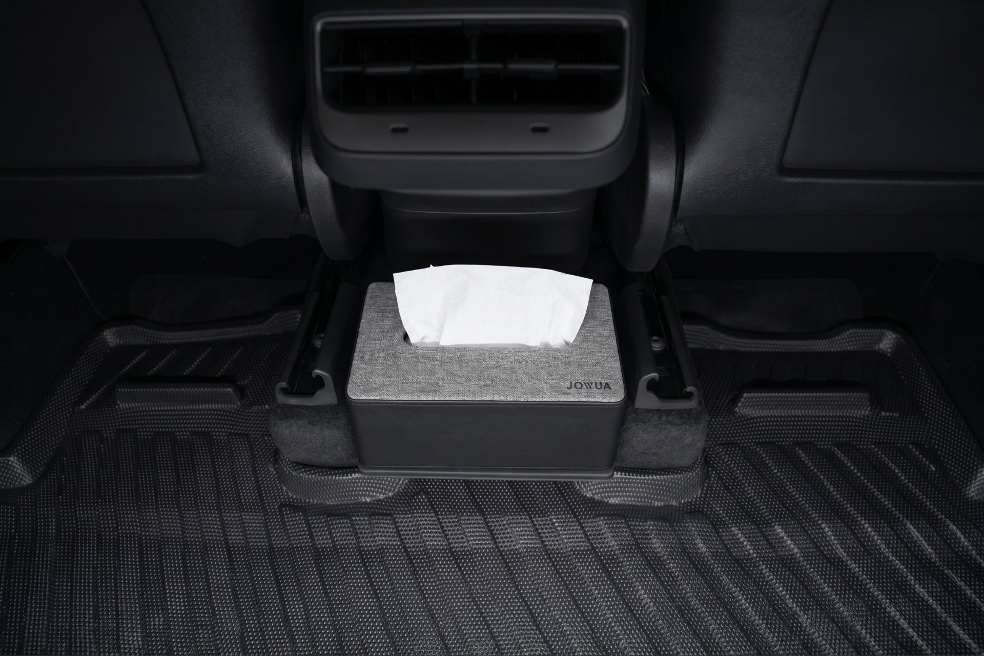 A tissue box rests on the textured black mat under the rear seat air vent cover, behind the center console—perfect with JOWUA Model Y (2021-2024) All-Weather Floor Liners Combo.