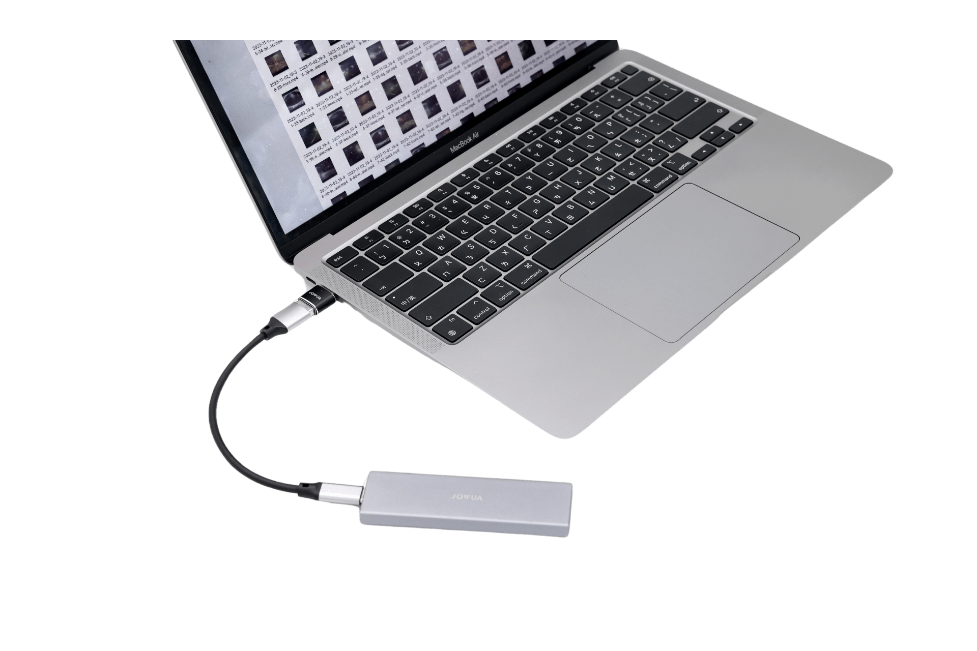 A silver laptop is connected to a JOWUA Sentry & DashCam Adapter Set OTG (USB-A to Type-C & Lightning) via a black USB-C cable, with the keyboard and touchpad visible, highlighting its dashcam and OTG functionality.