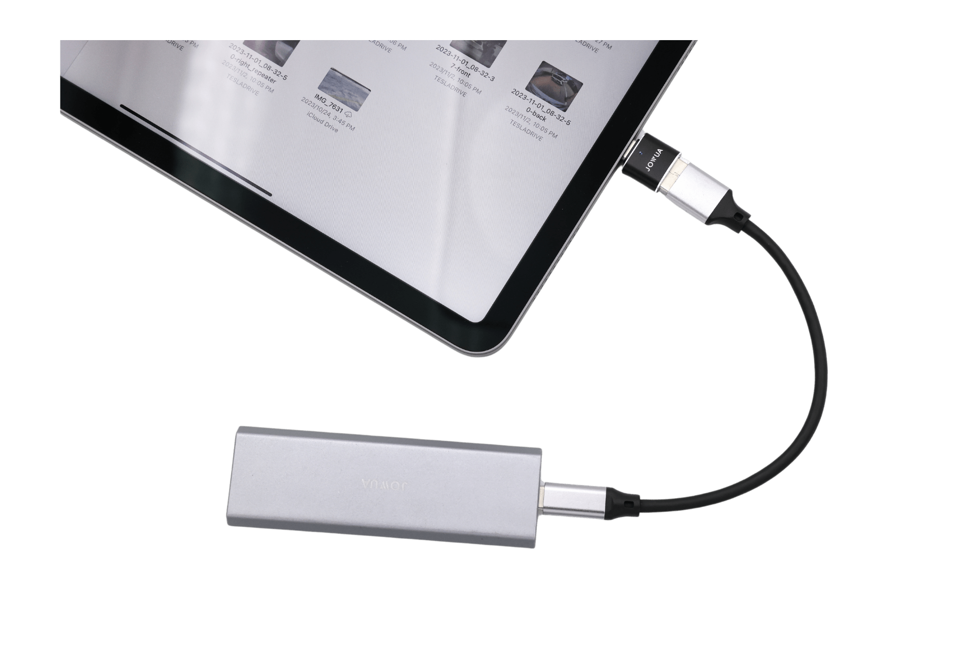 A JOWUA Sentry & DashCam Adapter Set OTG (USB-A to Type-C & Lightning) connects a tablet, via a black USB-C cable, to a silver external device. The tablet screen shows multiple image thumbnails.