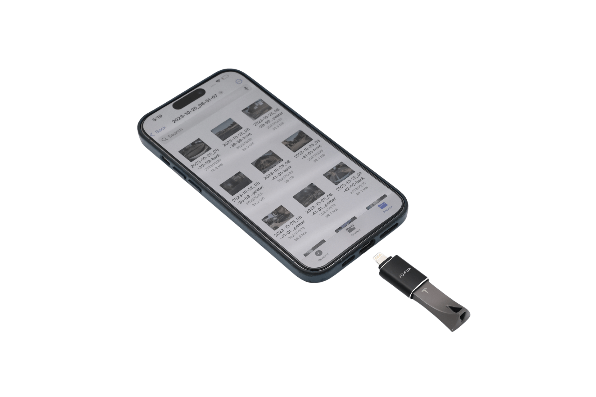 A smartphone displays files while connected to a Sentry & DashCam Adapter Set OTG (USB-A to Type-C & Lightning) by JOWUA, linking it to a black Tesla dashcam USB flash drive.