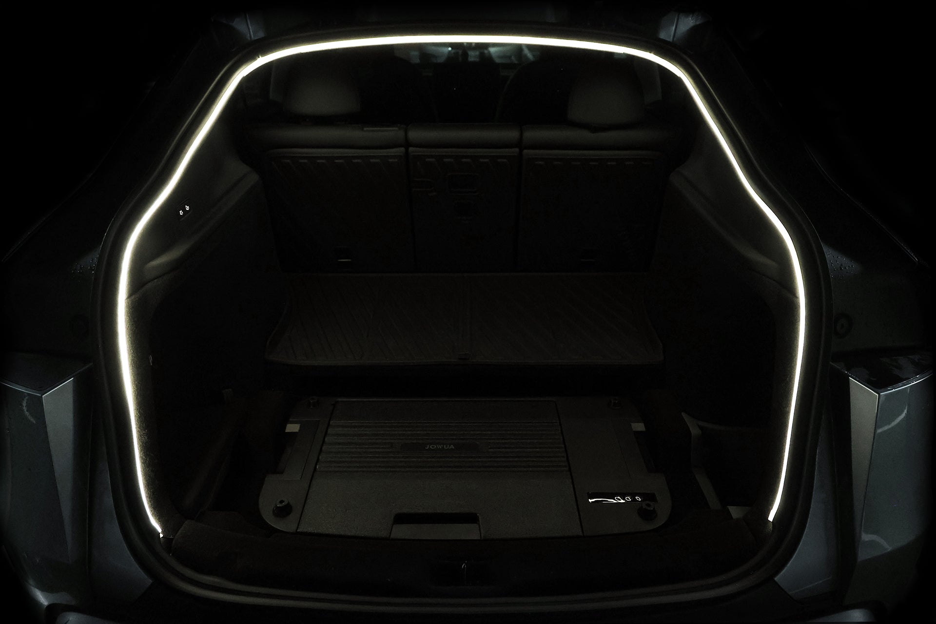 The JOWUA Tesla Model Y Trunk Ambient Light is a USB-C LED strip outlining the trunk edge, featuring a magnetic induction auto-switch that highlights the spacious cargo area and rear seats for added convenience.