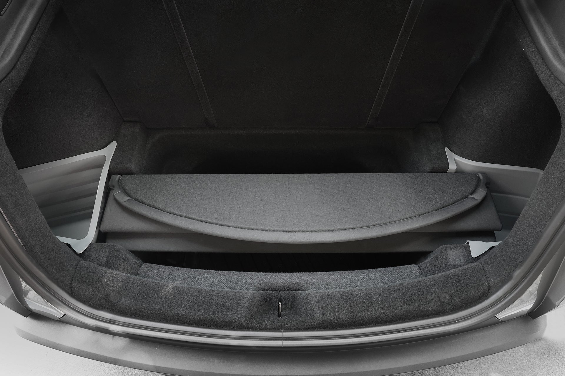 Open Model Y trunk to reveal the JOWUA Model Y Juniper Trunk Combo (2025+): a clean, spacious cargo area lined with dark fabric and protected by a waterproof trunk mat, with the retractable cover partially extended for easy access.