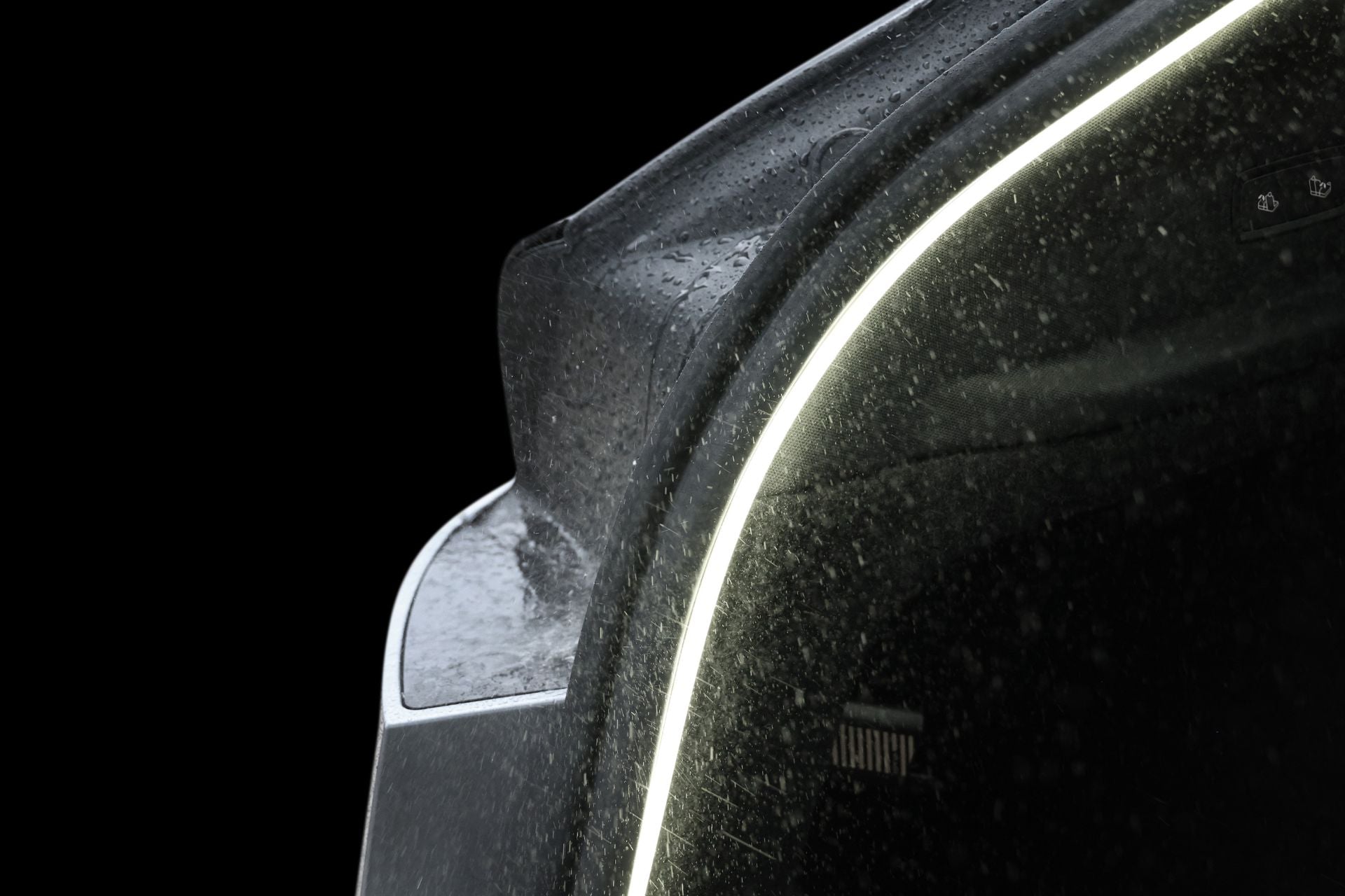Close-up of JOWUA's Teslussy Light > Type-C Ambient Light & 3 in 1 Car Charger (Tesla Model Y) highlighting water-kissed LED accents and side mirror, with an ambient LED strip curving along the front against a black background.