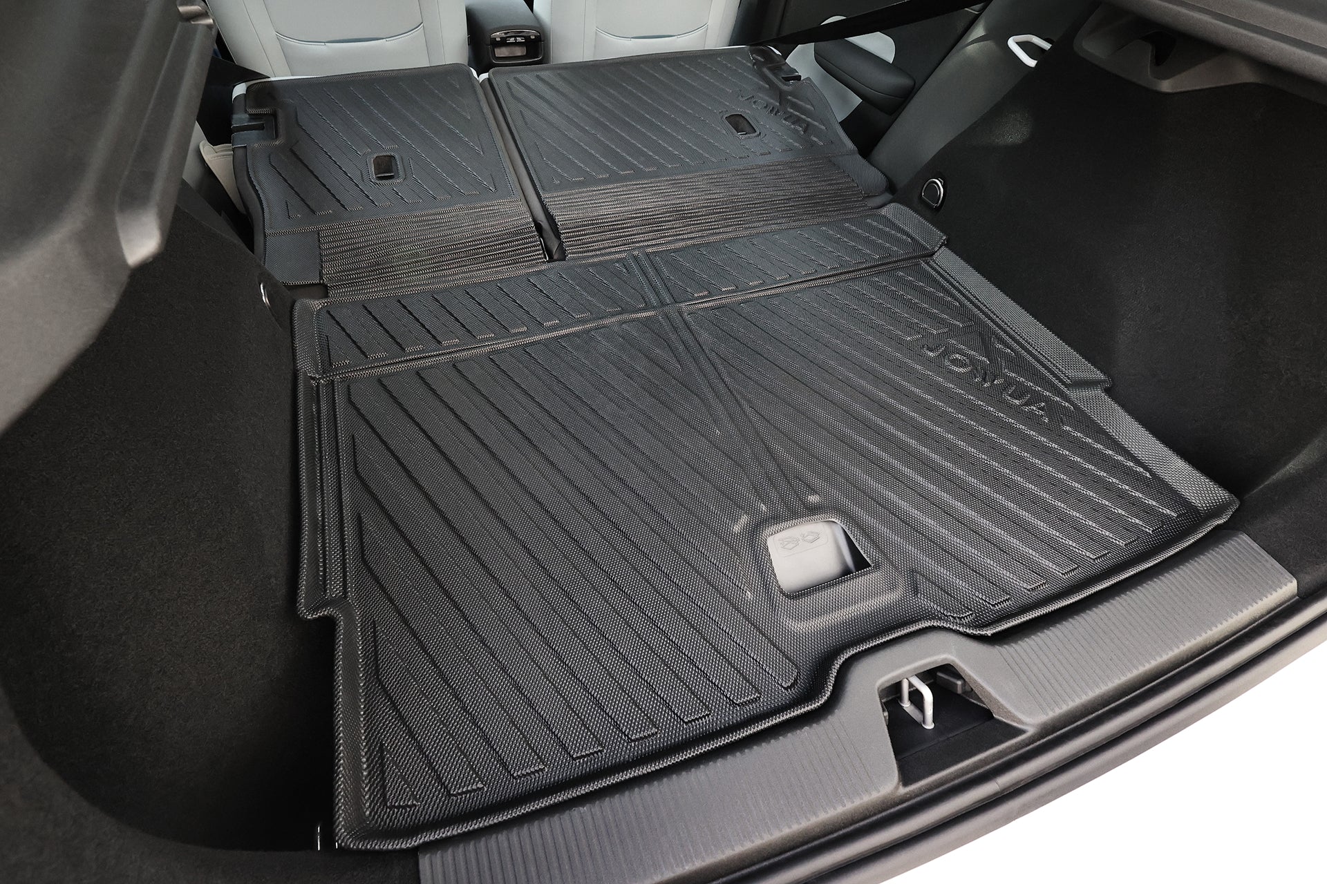 Close-up of a Volvo EX30’s rear cargo area, featuring the JOWUA All Weather Trunk Liner and Rear Seat Cover. This custom-fit set creates a flat, extended loading surface that protects your car while transporting large items.