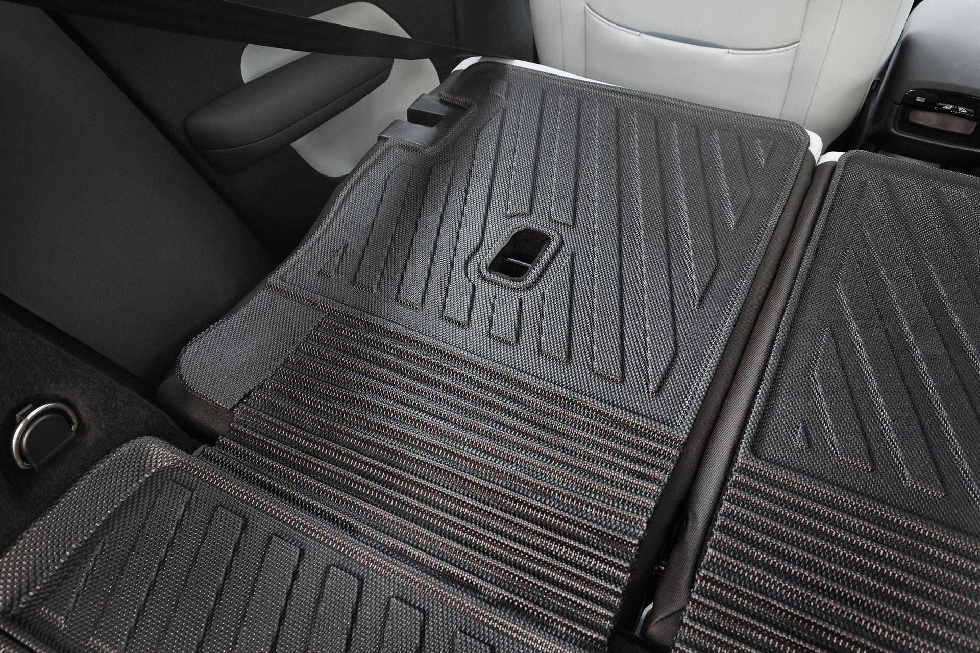 The image displays the JOWUA All Weather Trunk Liner + Rear Seat Cover for Volvo EX30, with rear seats folded down to showcase a flat cargo area protected by custom-fit, black textured covers for enhanced storage and cleanliness.
