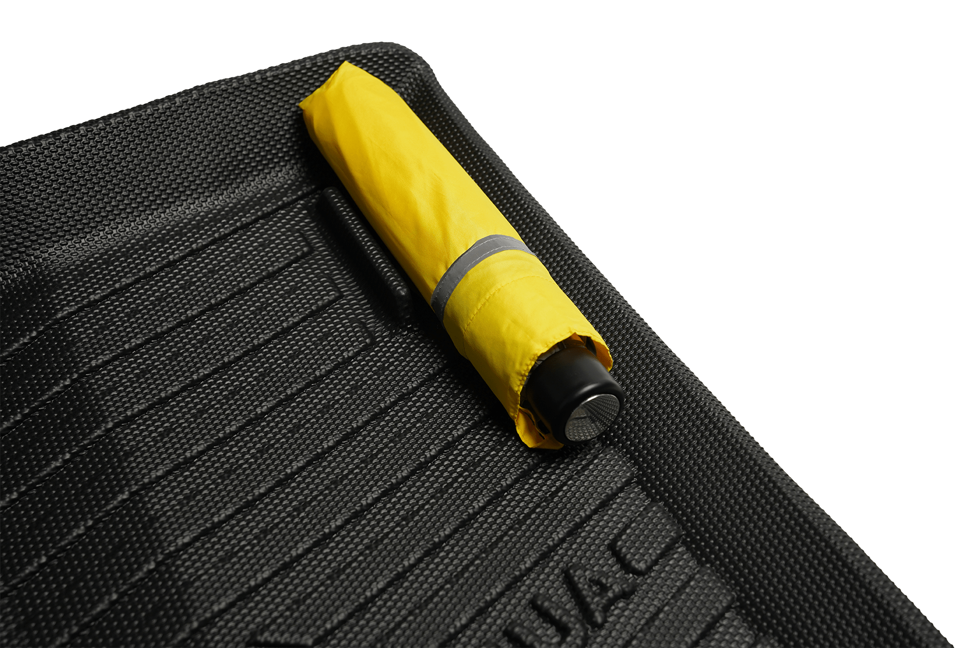 A small, closed yellow umbrella with a black handle rests on JOWUA’s Model 3 Highland 2024+ All-Weather Floor Liner (Right Hand Drive Version), showcasing the liner’s textured black surface.