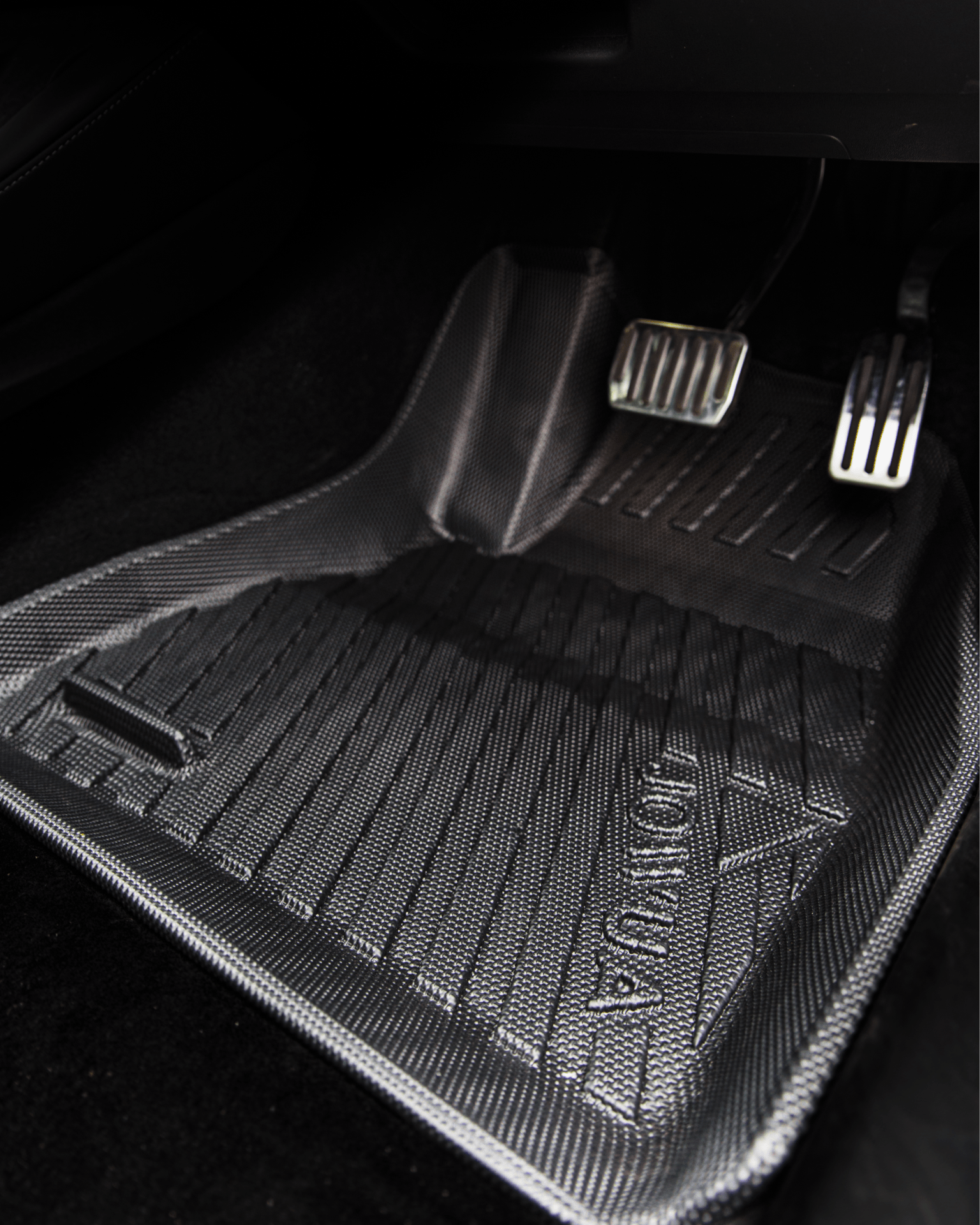 Close-up of a Tesla Model 3 Highland 2024+ (RHD) driver-side footwell featuring textured black JOWUA all-weather floor liners beside the accelerator, brake, and clutch—functional accessories for keeping your interior clean.