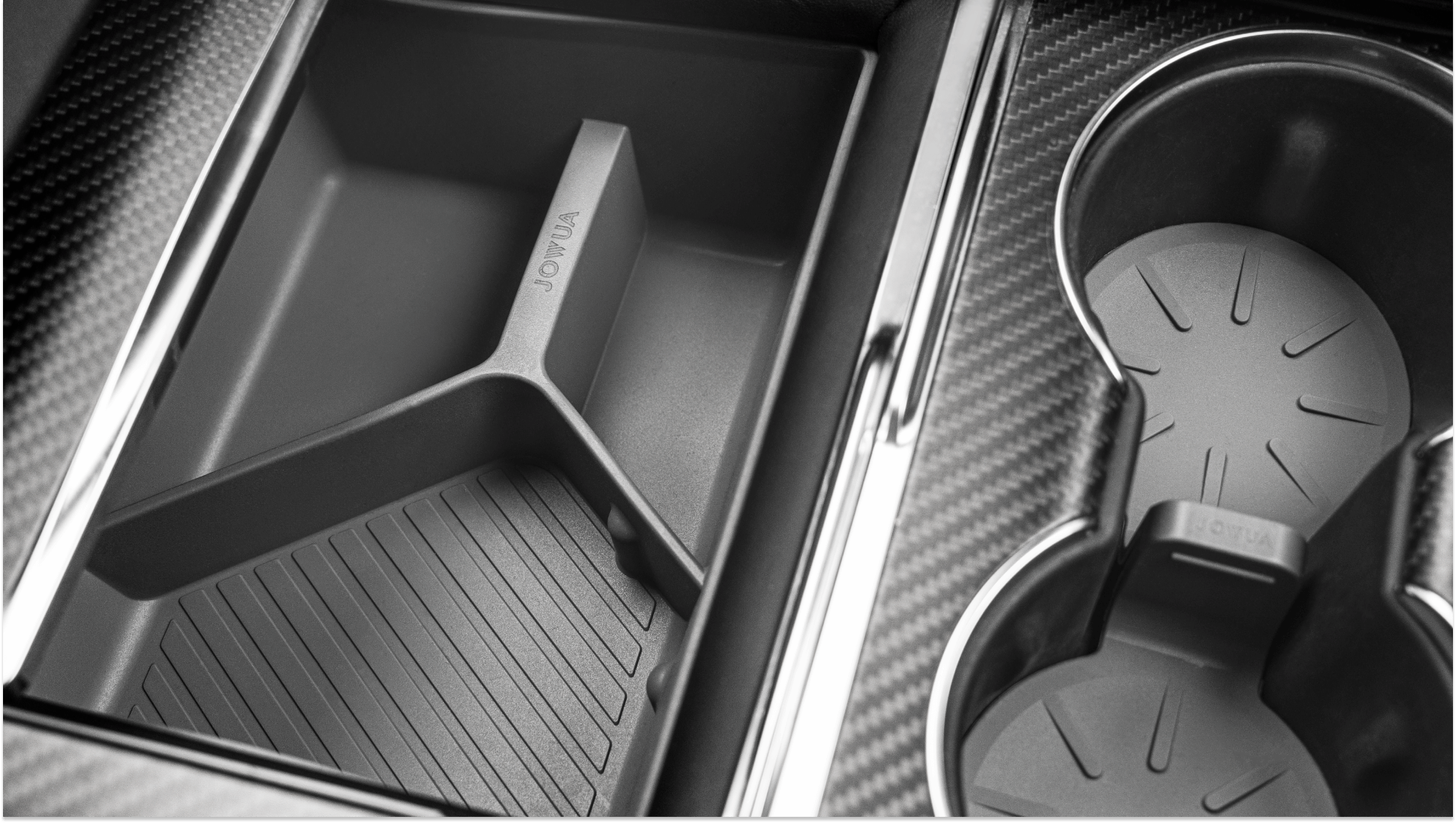 Close-up of a Tesla Model S center console featuring the JOWUA Center Console Set, which includes a premium silicone organizer with divided storage compartments on the left, showcasing vertical ridges, along with two cup holders on the right. The sleek, modern design is enhanced by a carbon fiber texture surrounding the compartments.