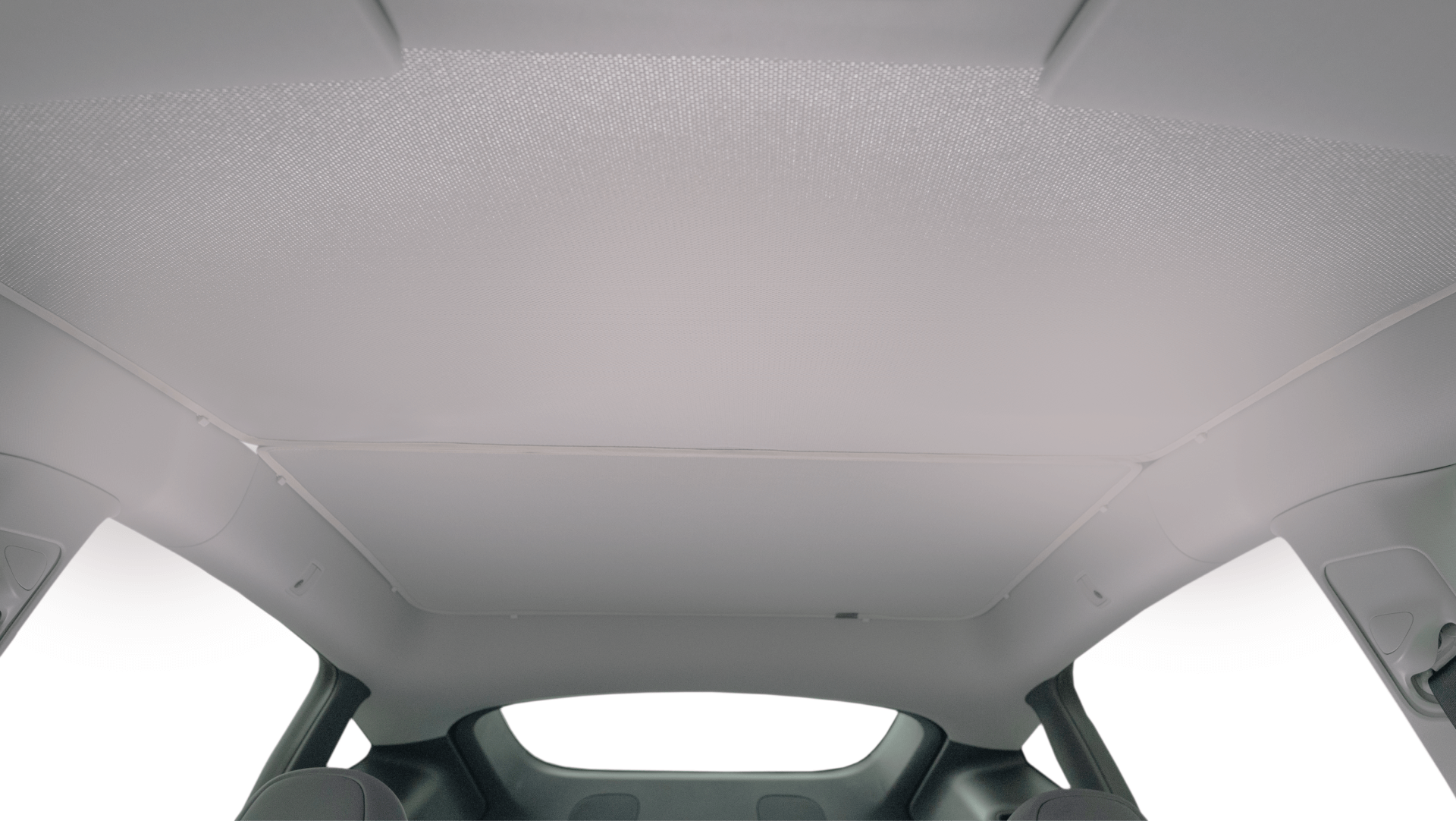 Interior view of a vehicle's panoramic sunroof, showcasing a light gray retractable sunshade. The roof frame is also visible, providing a spacious and modern design aesthetic.