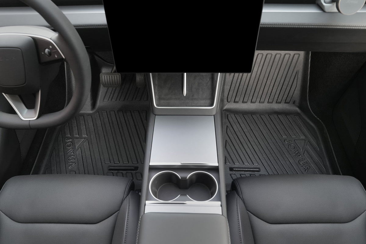 View of a car’s minimalist interior featuring the center console with cup holders, armrest, large touchscreen display, and JOWUA Model Y L (2026+) All Weather Floor Liner paired with black leather seats for a sleek look.