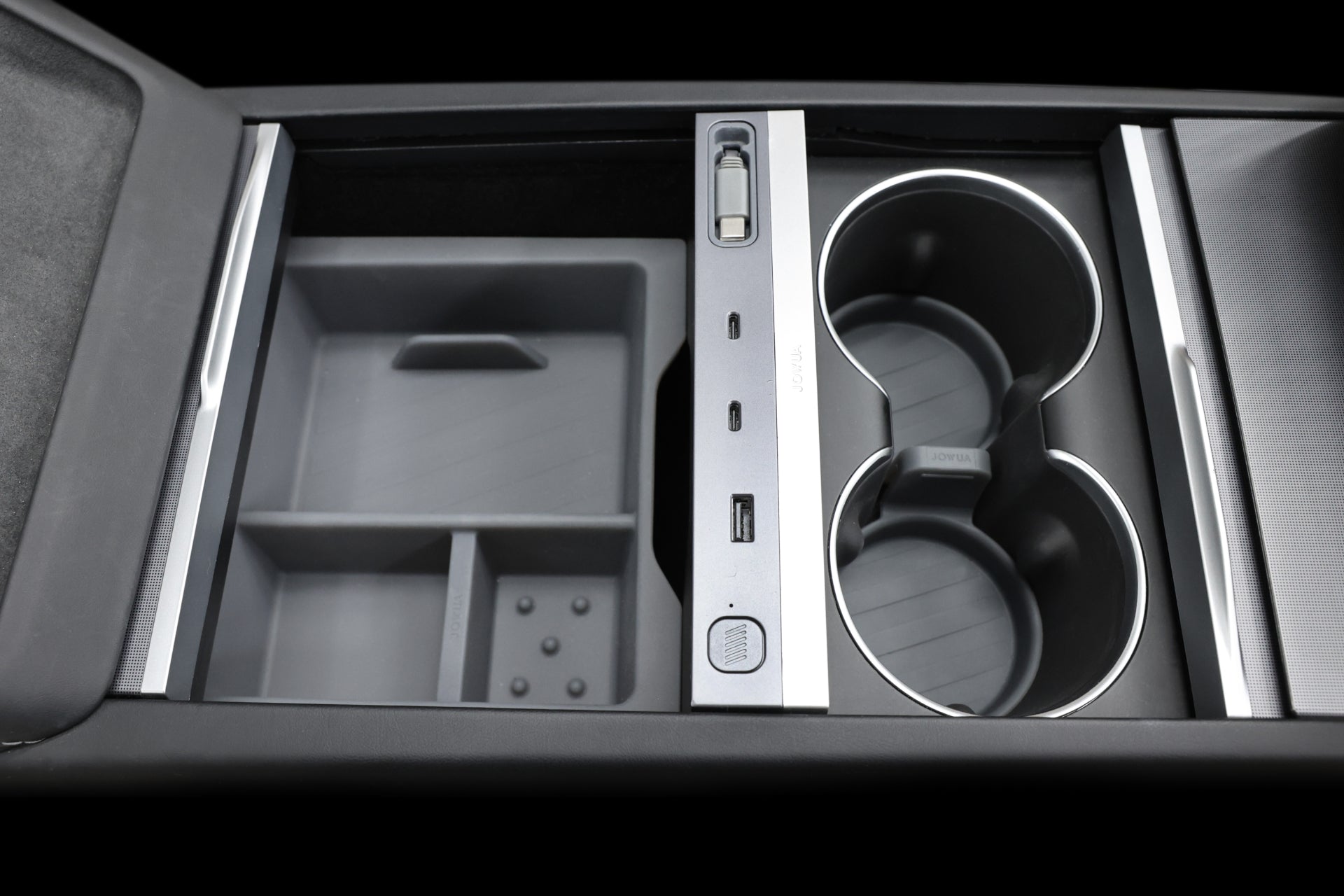 Close-up of the JOWUA 130W LED Hub for Tesla Model Y (Juniper 2025+) / Model 3 (2024+), featuring divided storage, a USB port, and a power button with dynamic power management. Two chrome-accented cup holders add to its sleek black and metallic design, combining charging and storage solutions.