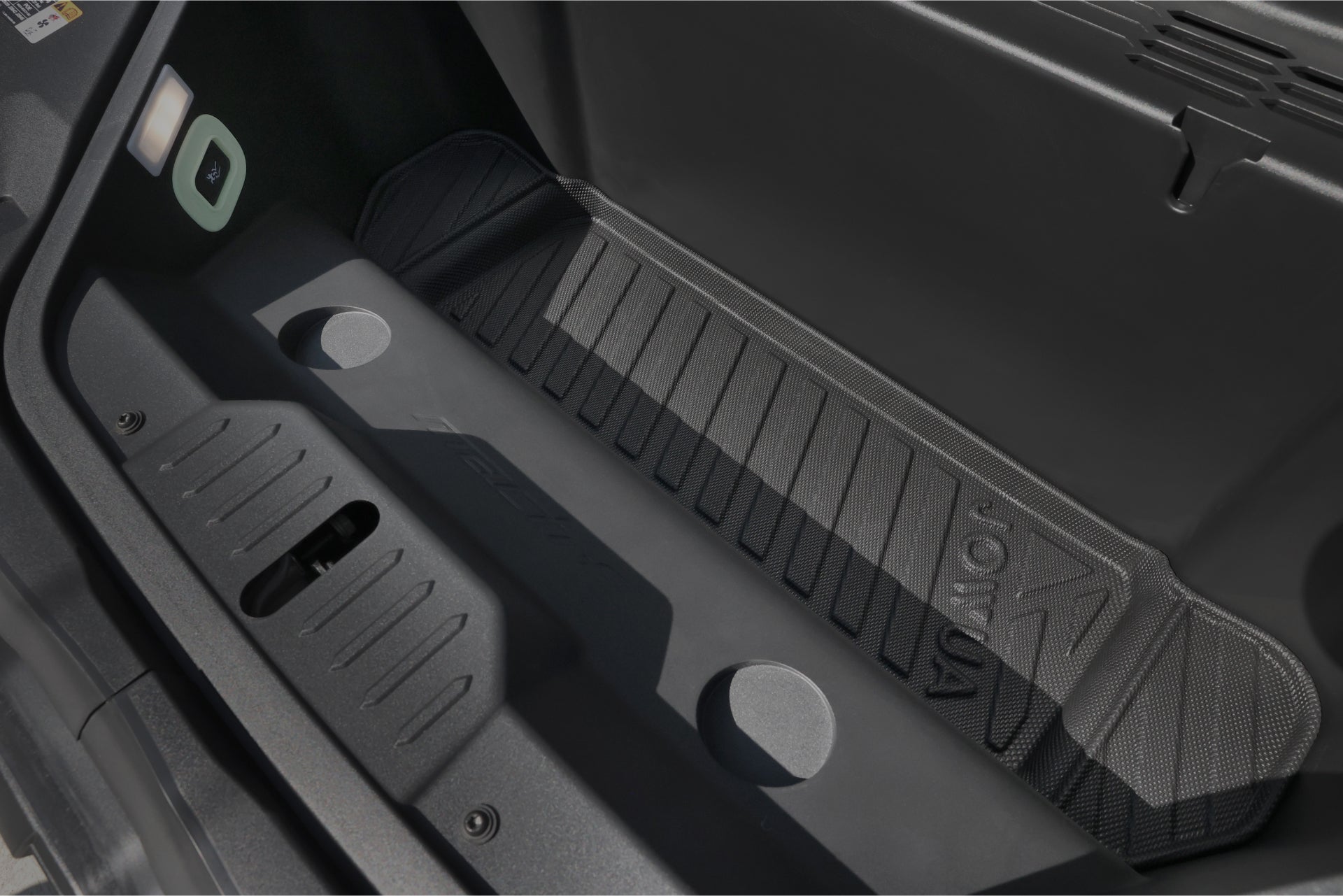 The image showcases the storage compartment of a vehicle, featuring JOWUA