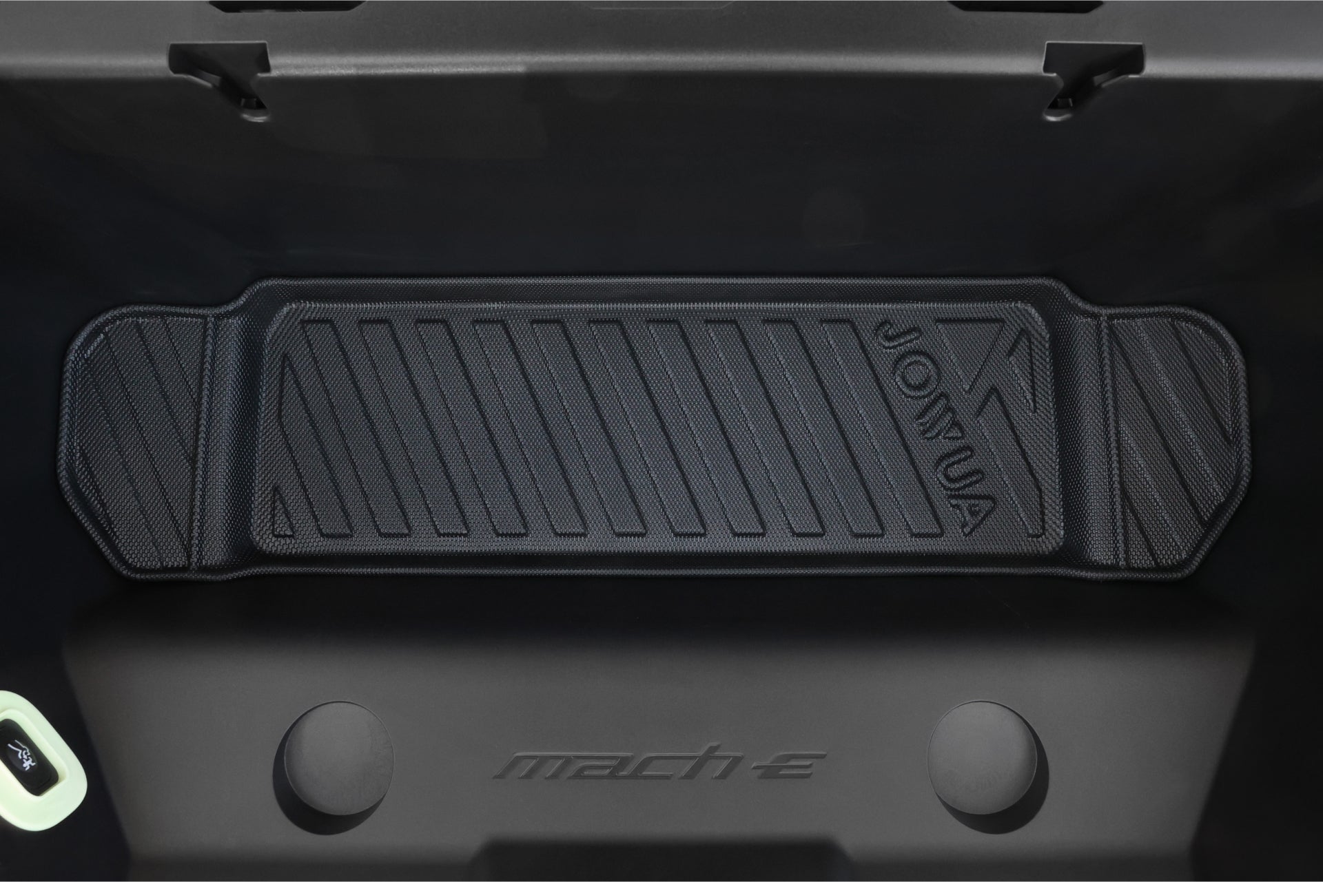 The interior of the car's front trunk (frunk) includes a foldable design with an all-weather liner. The rubber mat, called JOWUA's All Weather Trunk Liners for the Ford Mustang Mach-E, features sleek diagonal lines on a black surface, perfectly complementing the vehicle's style.