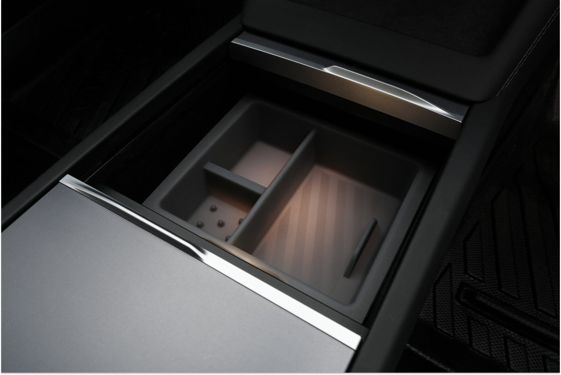 The JOWUA Tesla Model Y Juniper (2025+) Premium Bundle features a modern center console with a removable organizer tray, metallic trim, ambient lighting, and wireless charging, epitomizing luxury and convenience in the right-hand drive version.