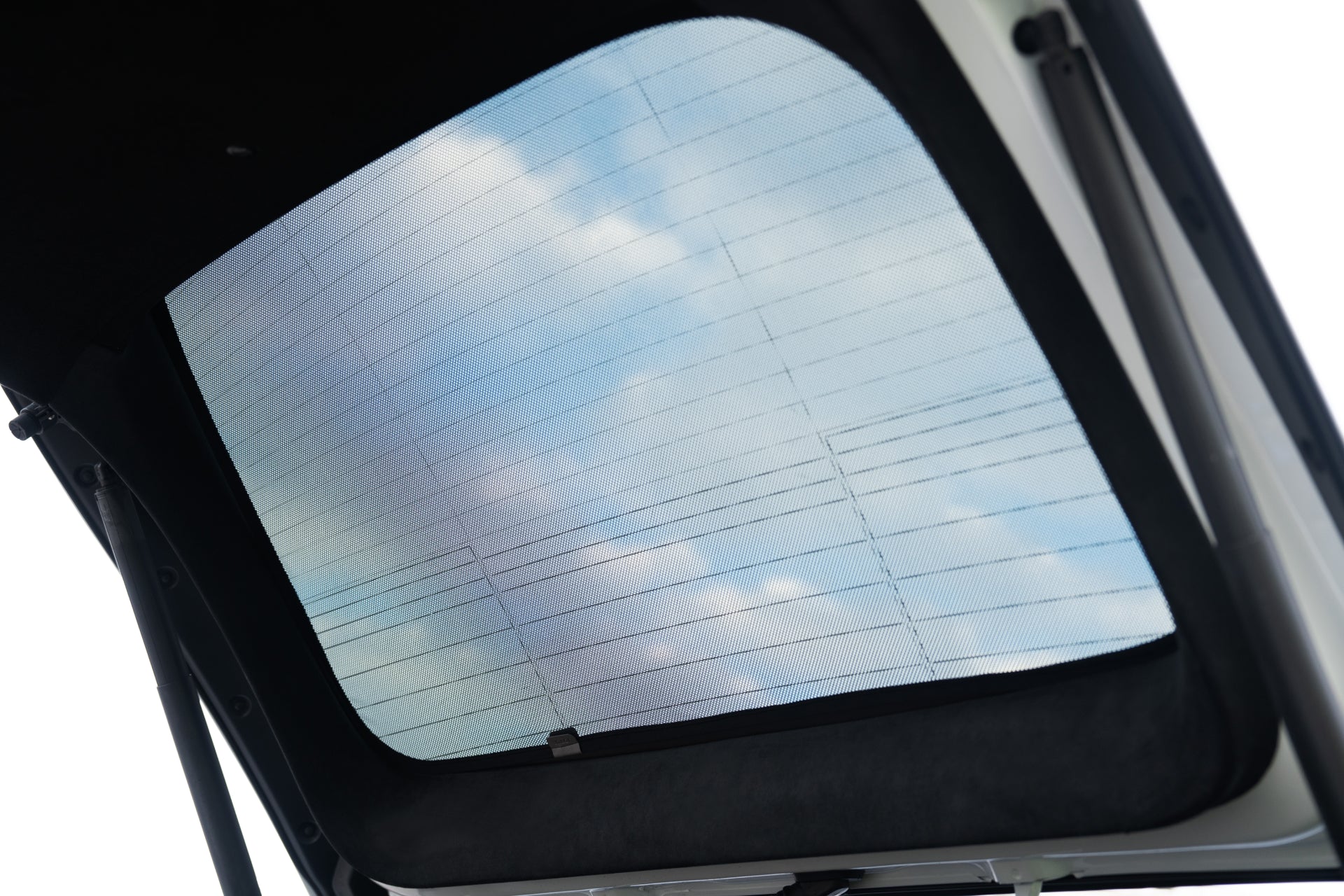 A clear car sunroof is partially open to a blue sky with clouds. The JOWUA Model X Separate Sunshade Bundle provides excellent heat insulation, ensuring a comfortable ride while enjoying the scenery.
