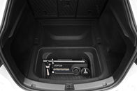 A black and white foldable electric scooter rests on the JOWUA Model Y EasyShield Waterproof Trunk Liner + Rear Seats Back Cover Bundle (Juniper 2025+/2018-2024), with the rear seats of the Tesla Model Y in view.