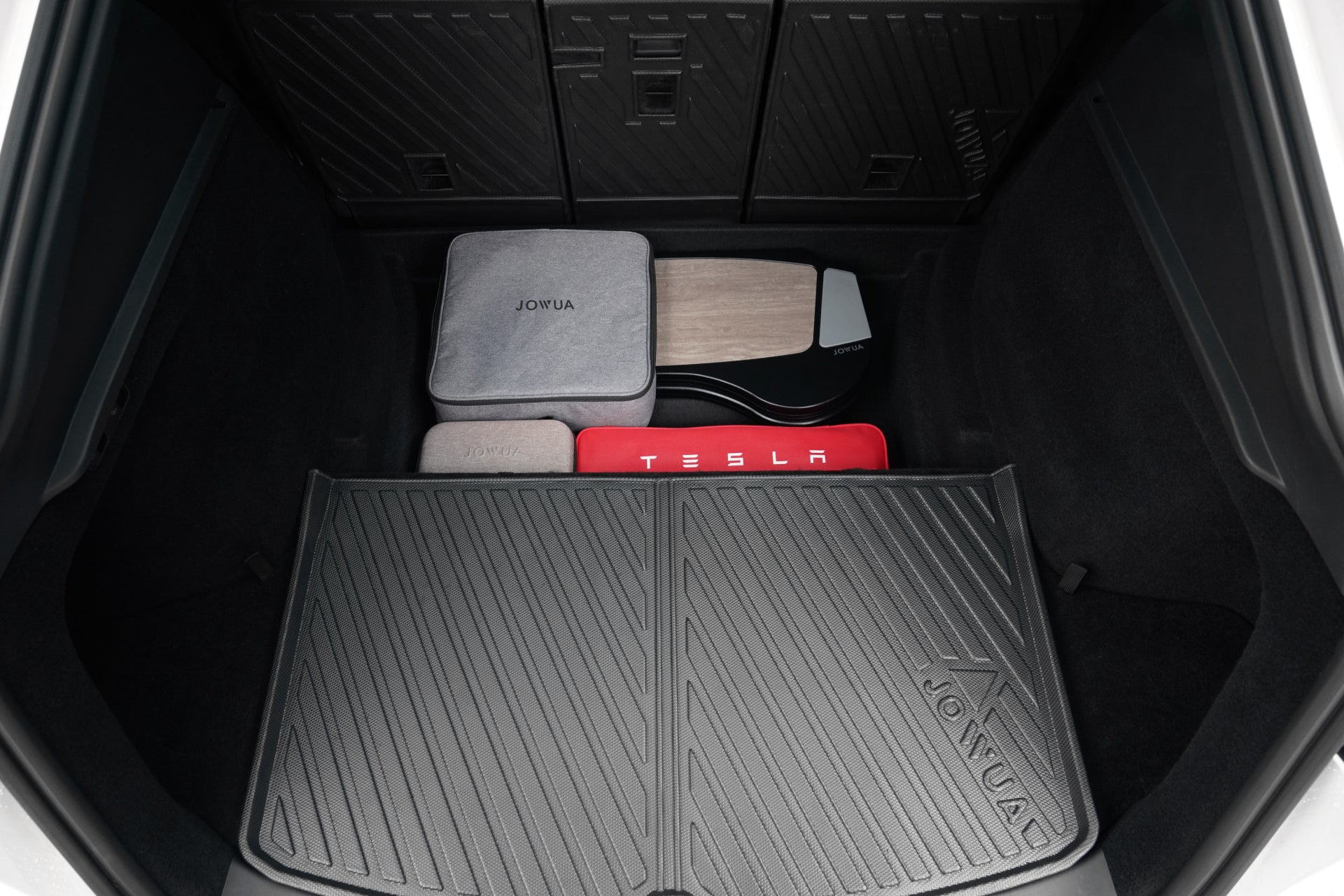 The clean trunk features the JOWUA Model Y EasyShield Waterproof Trunk Liner + Rear Seats Back Cover Bundle (Juniper 2025+/2018-2024), gray Jowua box, red Tesla case, and wood panel—perfect storage for any Tesla Model Y owner.