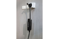 A black NEMA 14-50 Mobile Connector Adapter from JOWUA is plugged into a wall outlet against a gray wall. Featuring superior cable durability, the adapter
