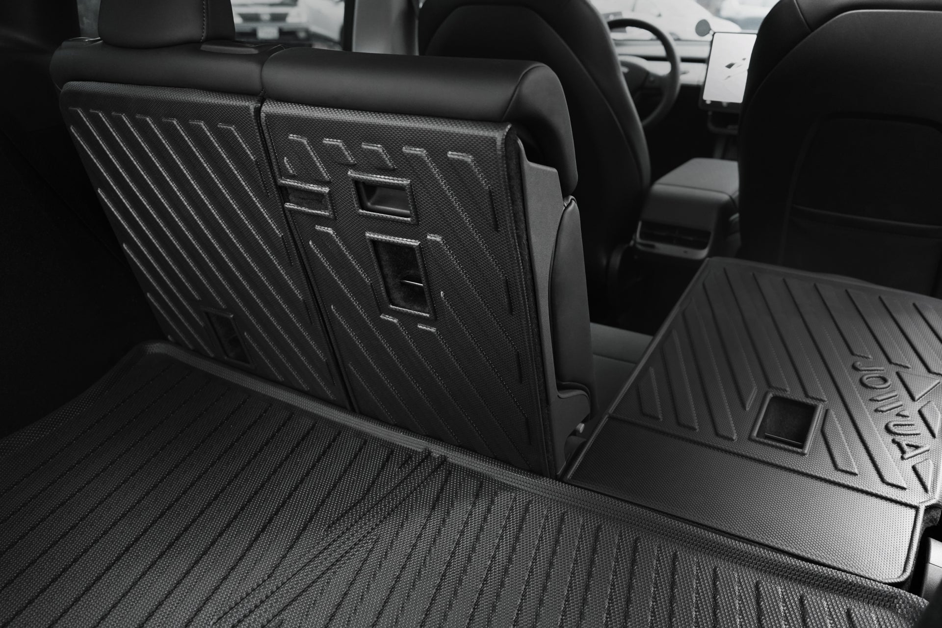 The image displays the JOWUA Model Y EasyShield Waterproof Trunk Liner + Rear Seats Back Cover Bundle (Juniper 2025+/2018-2024) installed, showing its geometric pattern for durability and easy cleaning, with a view toward the front seats and center console.