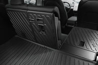 The image displays the JOWUA Model Y EasyShield Waterproof Trunk Liner + Rear Seats Back Cover Bundle (Juniper 2025+/2018-2024) installed, showing its geometric pattern for durability and easy cleaning, with a view toward the front seats and center console.