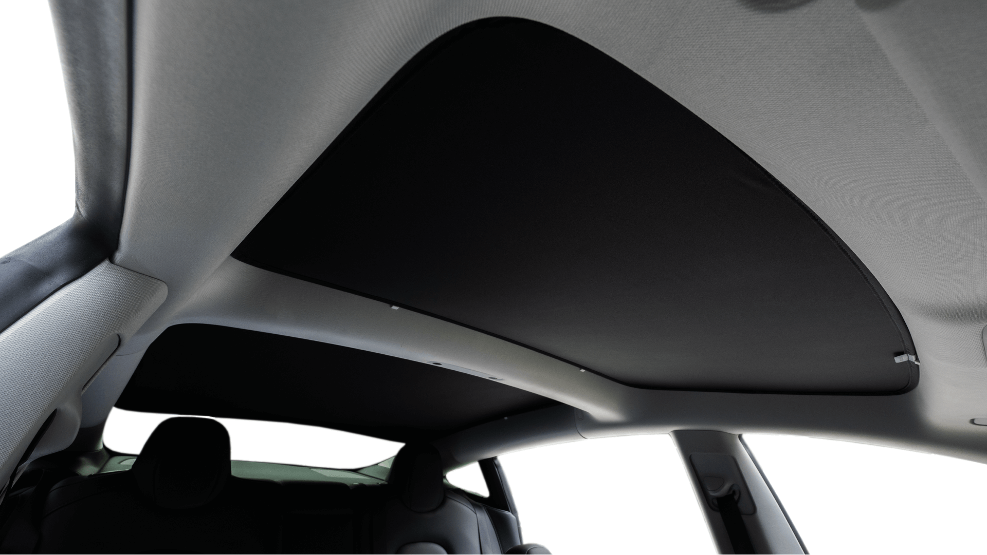View of a JOWUA Reengineered Model 3 Glass Roof Sunshade (US Version) interior from the back seat, highlighting a dark panoramic sunshade. The roof lining is light-colored and provides UV protection, with the seats partially visible.