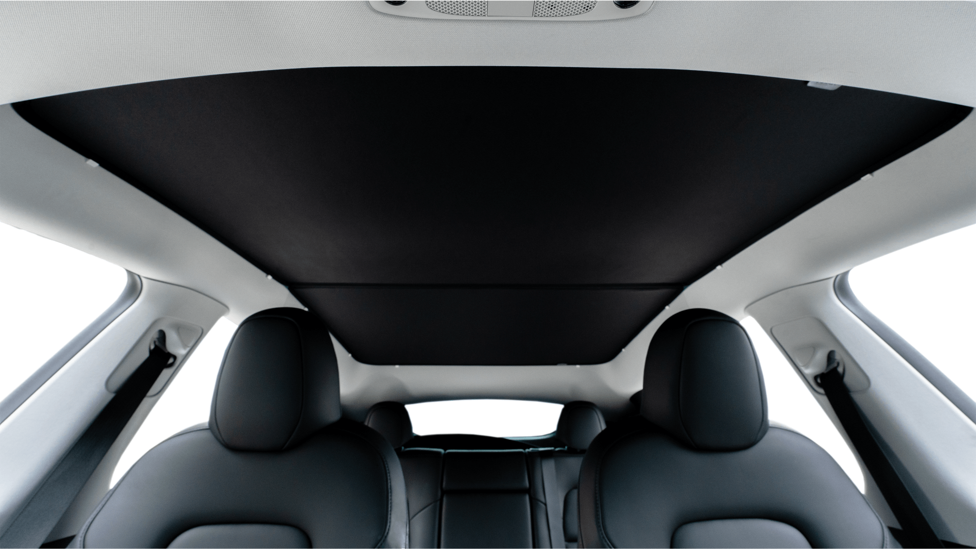 Interior of the vehicle showcases black and white upholstery. Highlighted is the panoramic glass roof with UV protection and a JOWUA black sunshade from the All Model Y (Juniper 2025+ / 2021-2024). Front seats boast a minimalist design with mesh fabric, merging style and comfort.