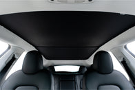 The interior view of the car highlights sleek black leather seats and a panoramic sunroof, partially covered with JOWUA