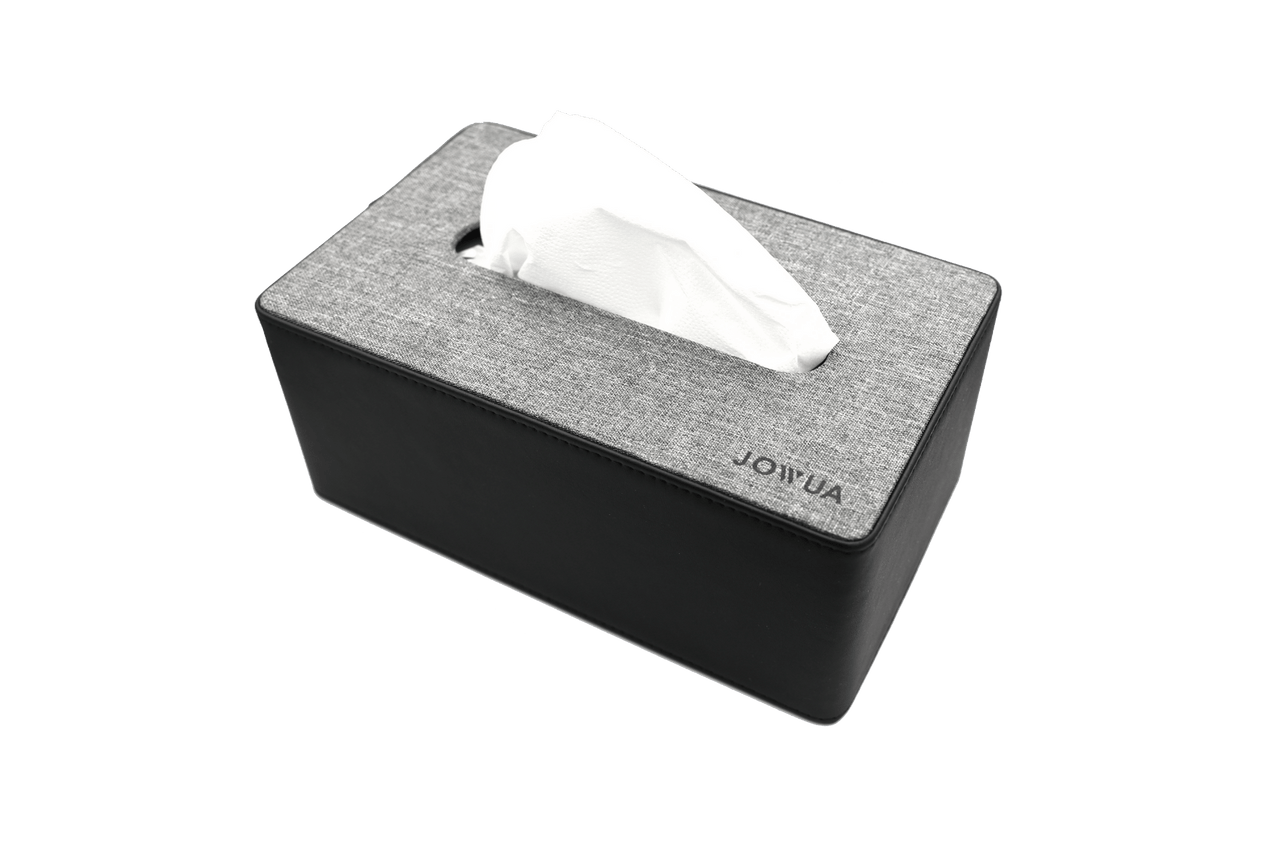 The JOWUA Tissue & Storage Box showcases a gray fabric cover combined with a black base, crafted from premium materials. It is defined by an open slot at the top, where a white tissue is partially pulled out.