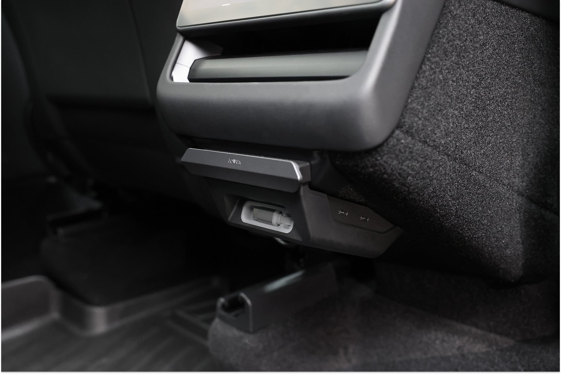 Close-up of the backseat in a car featuring the JOWUA 130W LED Rear Vent Hub for Model 3 Highland 2026+ and Model Y Juniper 2026+, with fast charging USB-C ports, an air vent on the rear center console, visible seat details, and subtle LED footwell lighting.
