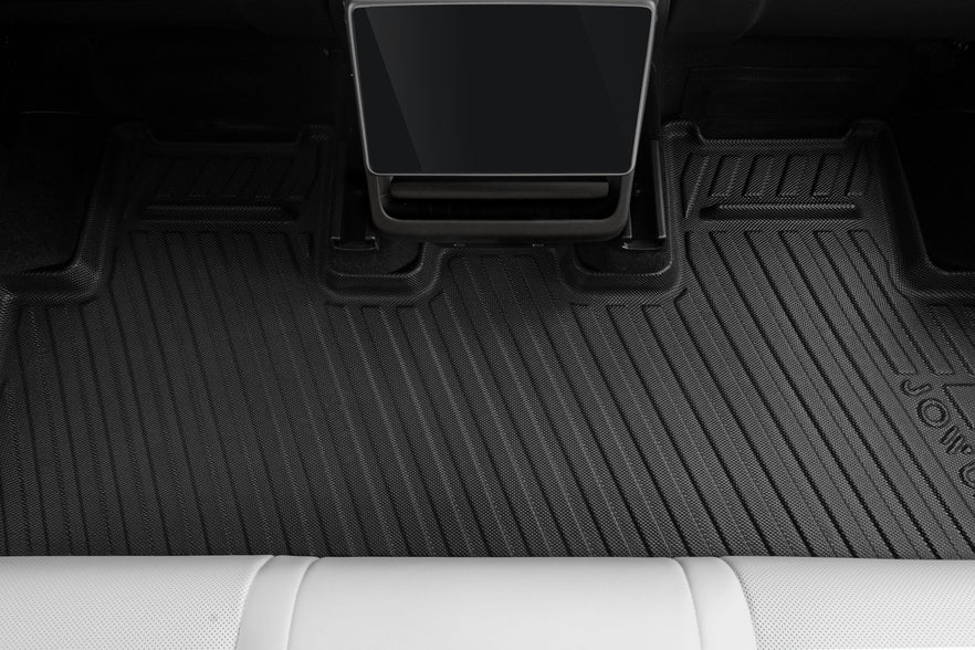 JOWUA’s All Model Y All-Weather Floor Liners Combo (Juniper 2025+ / 2021-2024) offers rear footwell protection, seen here under a touchscreen display and white seat—ideal for Tesla Model Y accessories fans.