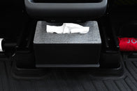 A gray tissue box with a textured cover sits on JOWUA All Model Y All-Weather Floor Liners Combo (Juniper 2025+ / 2021-2024) under a seat. Two tissues are partially pulled out, and a red item to the right adds to the accessory display.