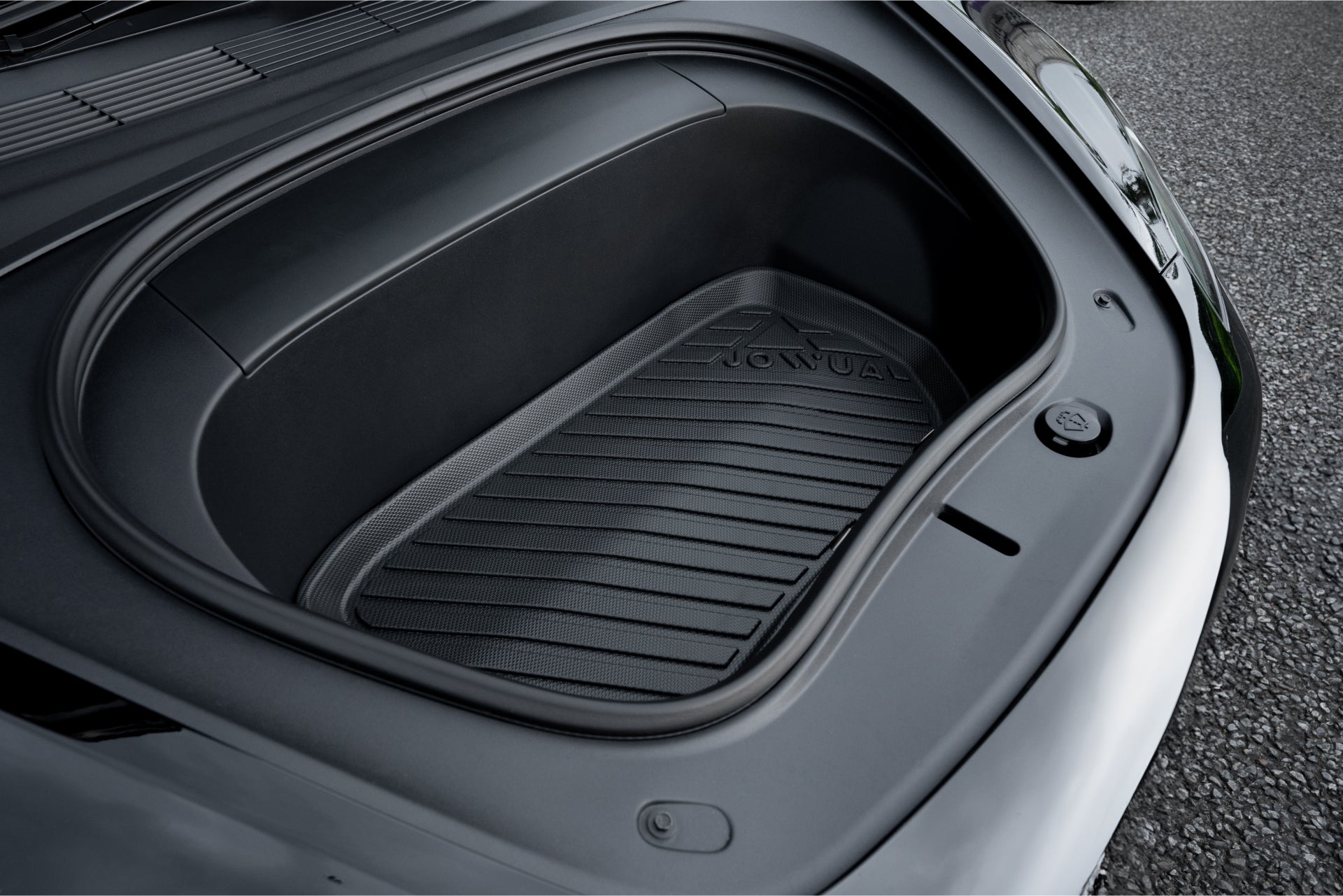 Close-up of an empty JOWUA Model 3 All Weather Trunk Combo (Reengineered Model 3 Highland, 2024+) with a rubber mat, highlighting its sleek and minimalistic design. The open trunk reveals a smooth, dark interior crafted from waterproof TPE material. The car is parked on a paved surface.